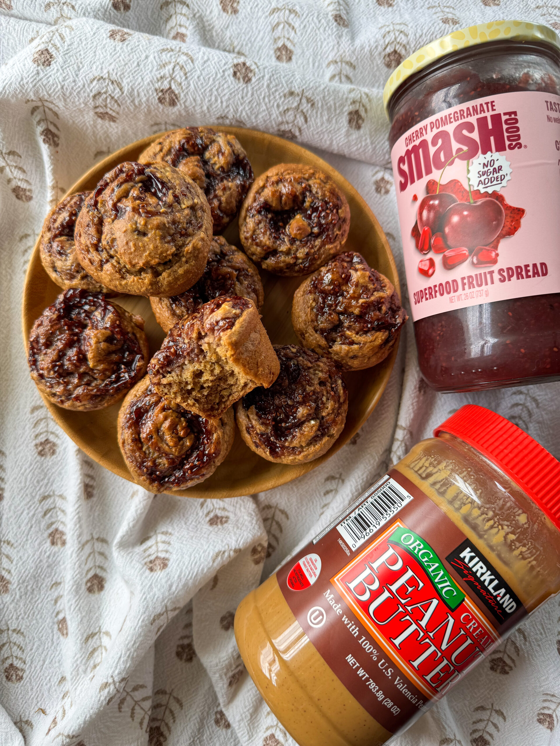 Ingredients for peanut butter and jelly oatmeal muffins including oats, banana, peanut butter, and jam