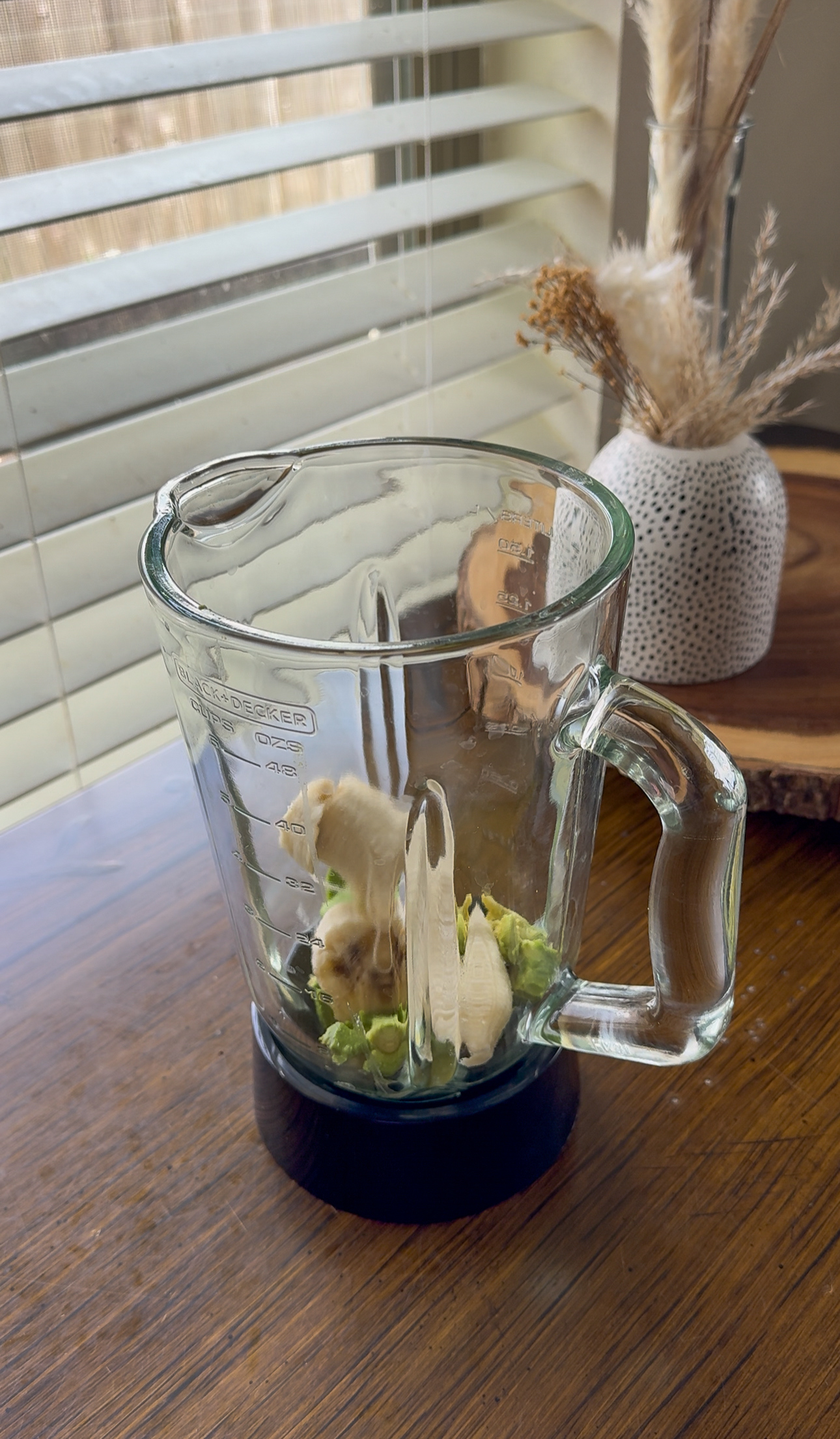 adding banana avocado smoothie ingredients