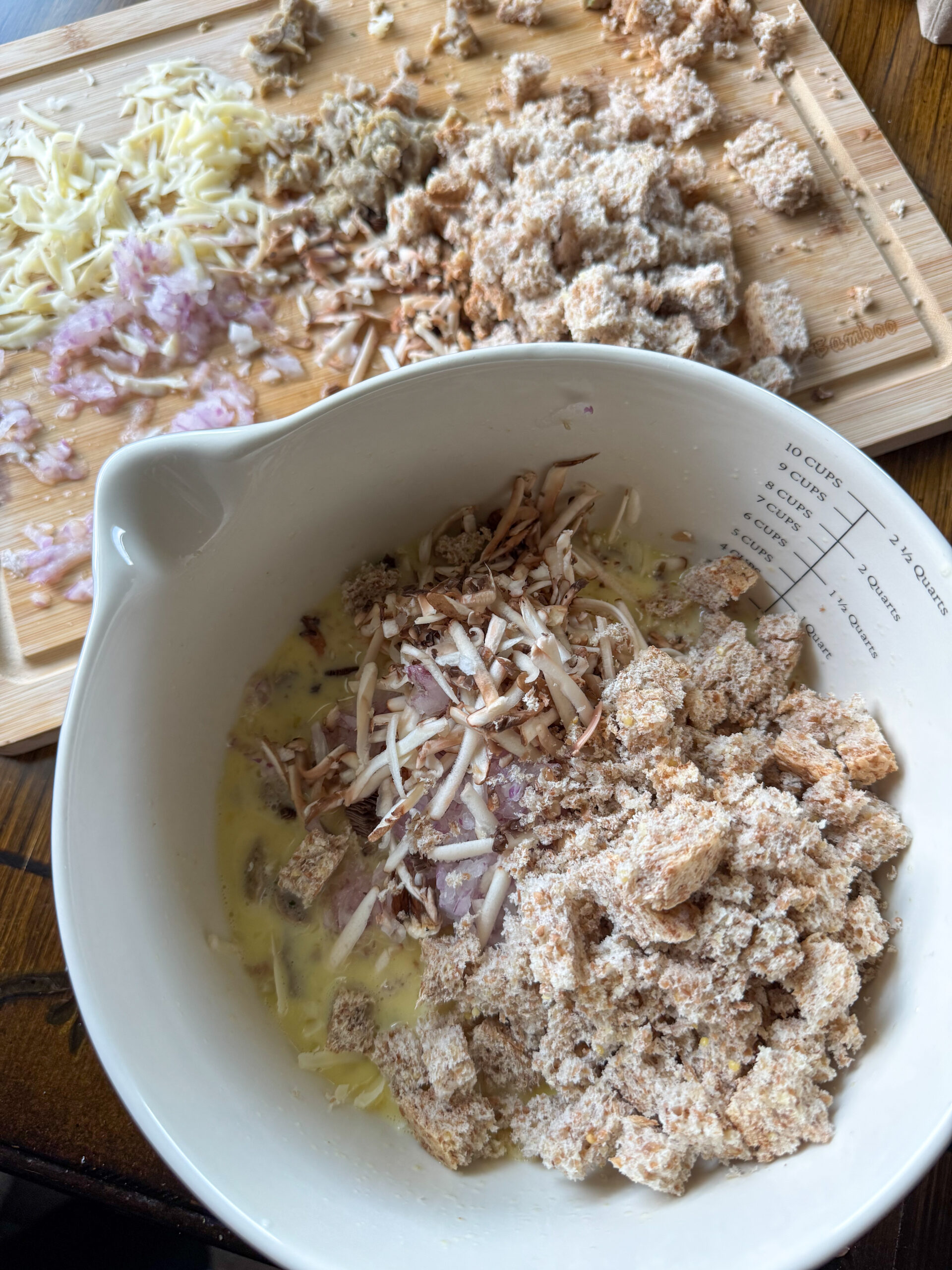 adding ingredients in bowl for savory breakfast muffins