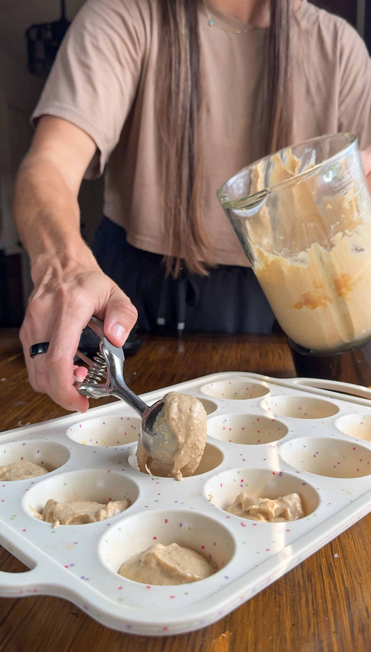 scooping mix into muffin tin