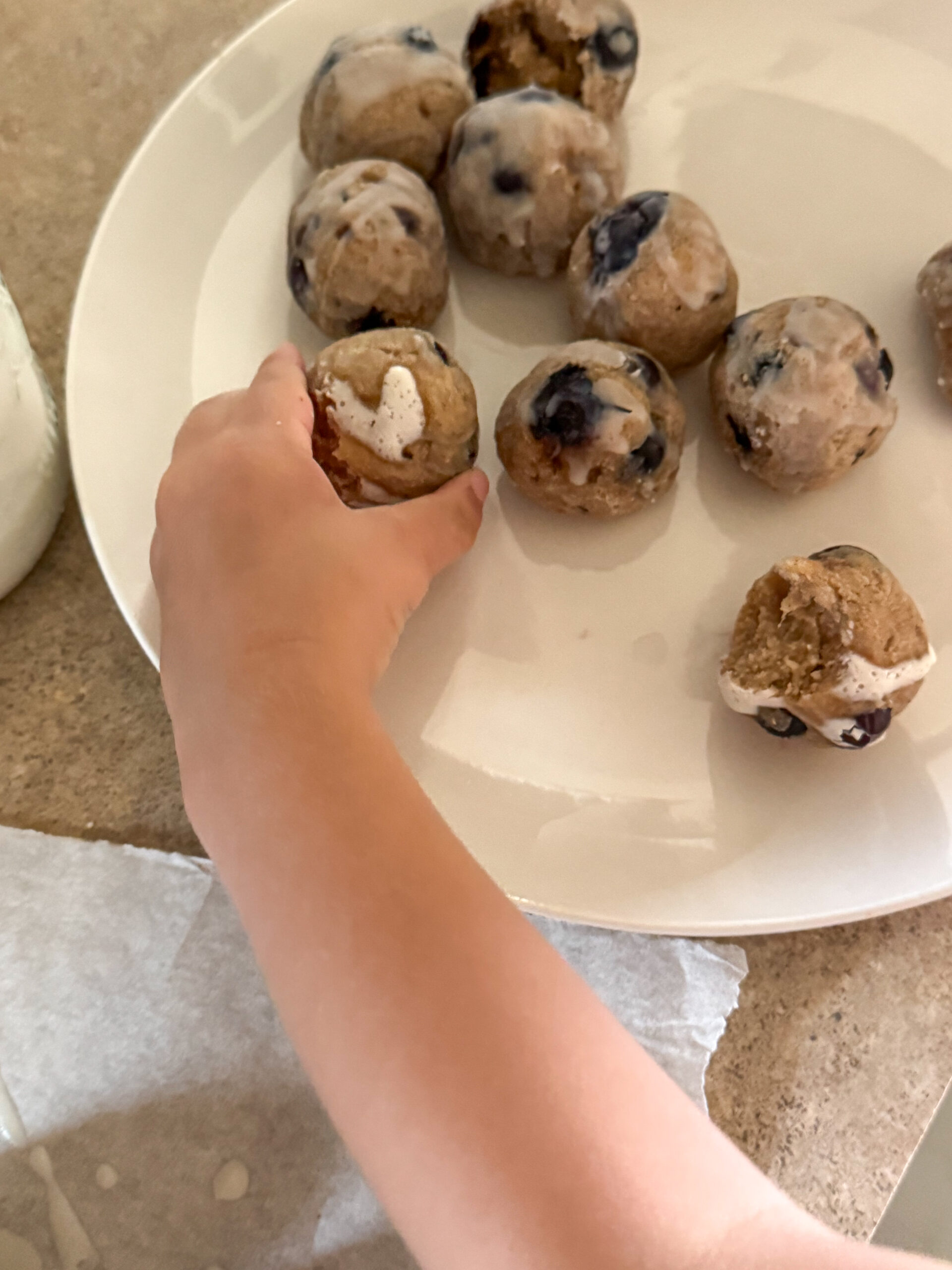 toddler hands grabbing donut hole
