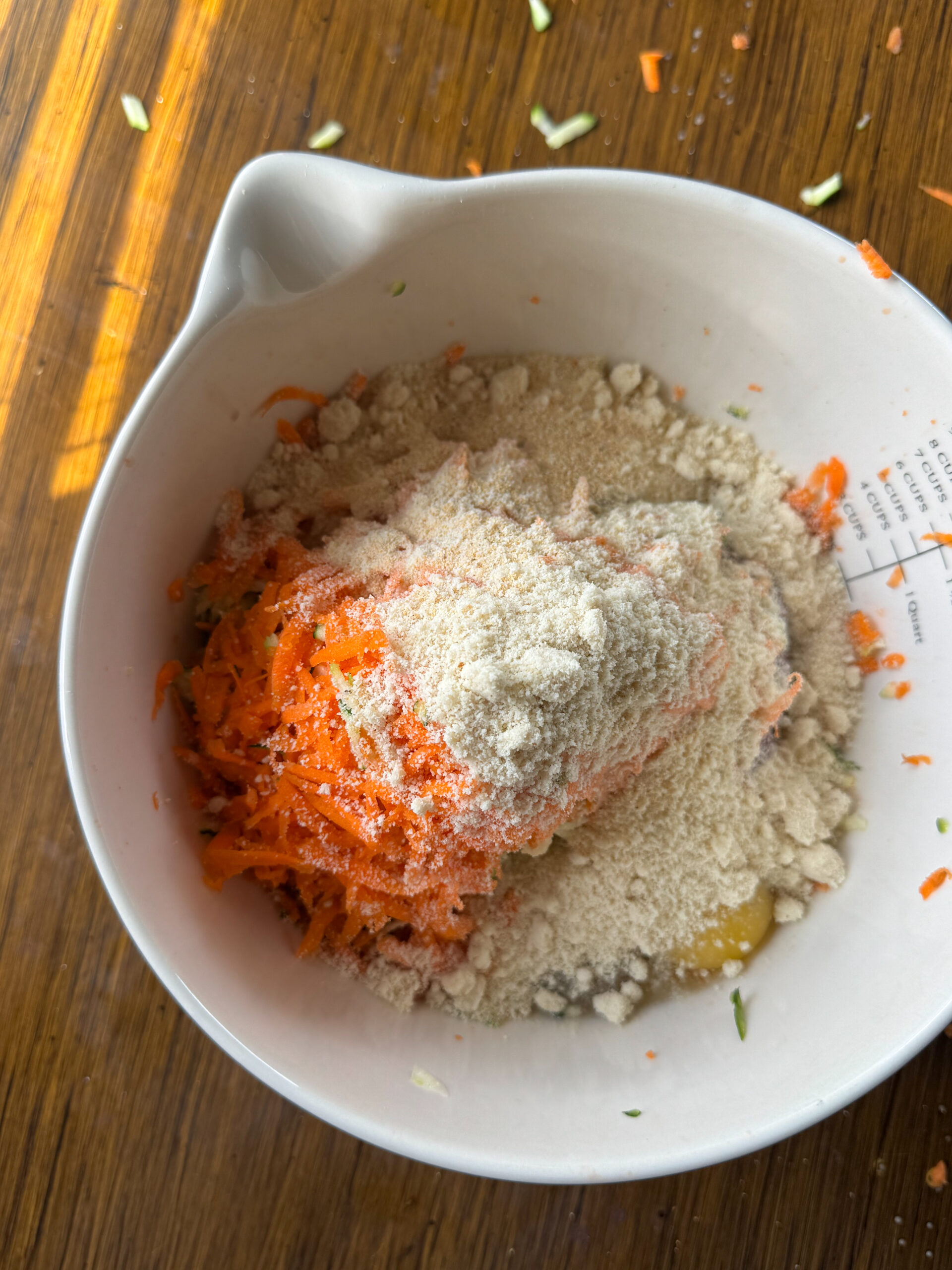 adding all the meatball ingredients in a white mixing bowl