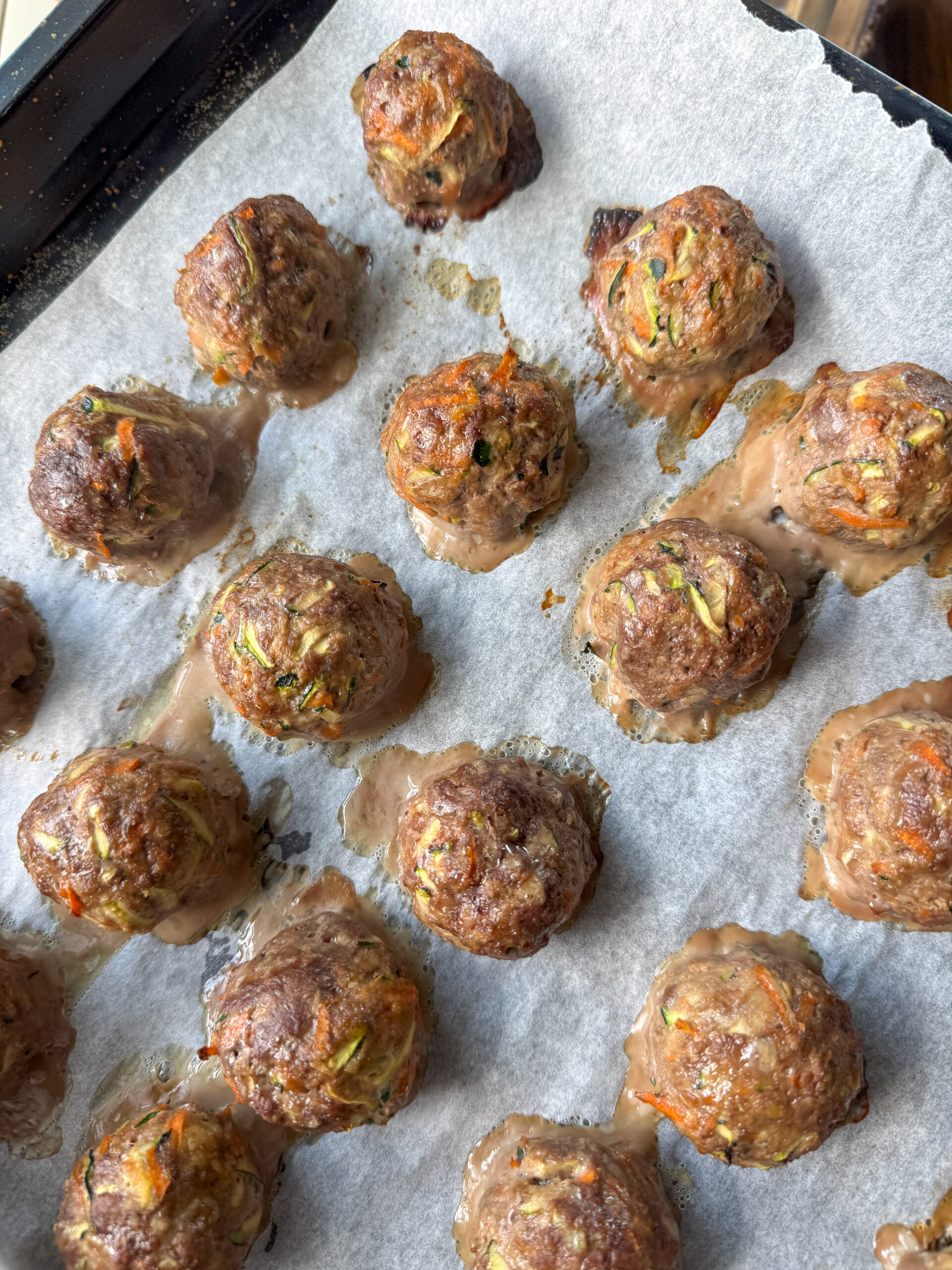 cooked meatballs on a baking sheet