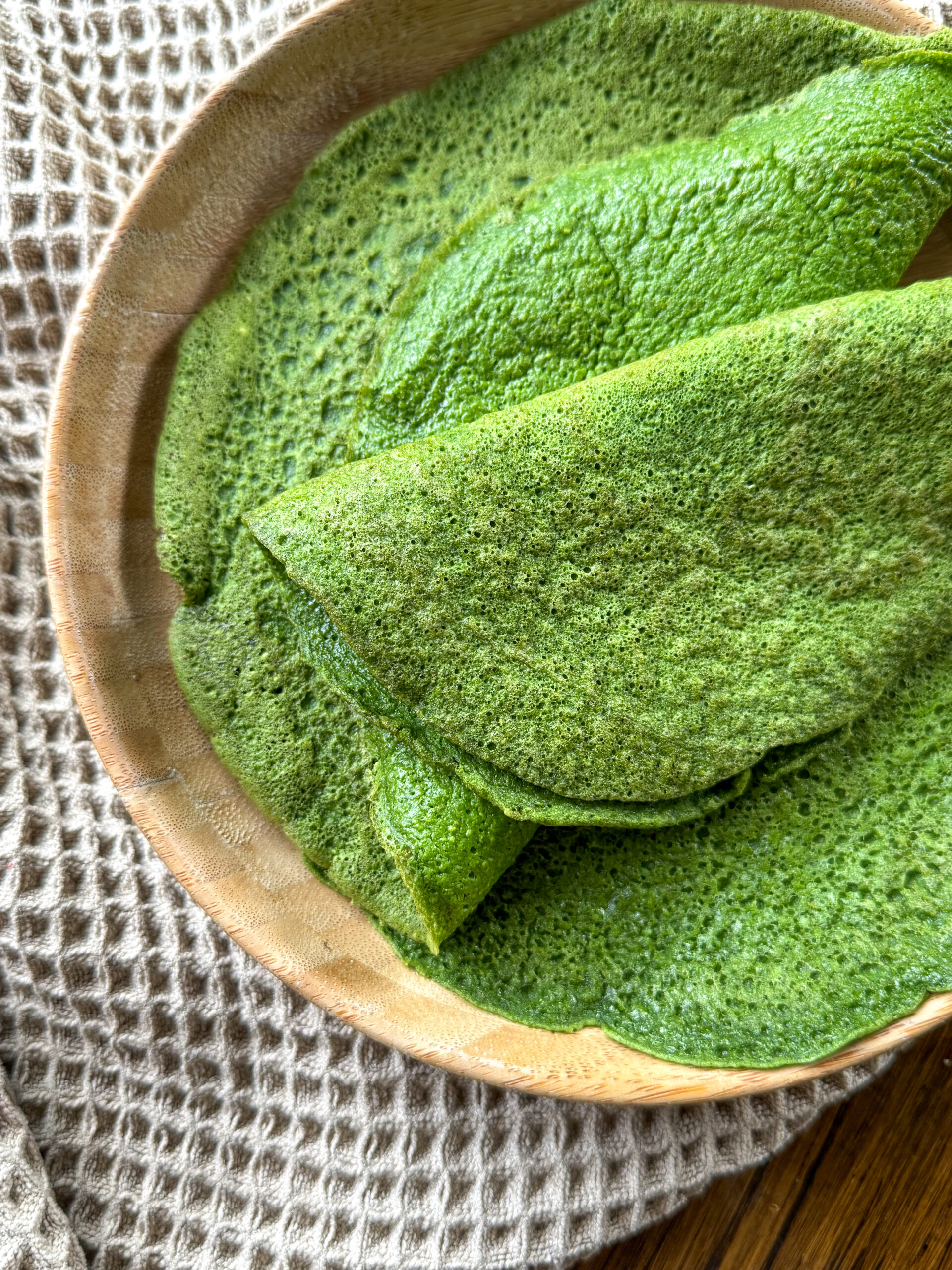 spinach wraps on a wooden plate