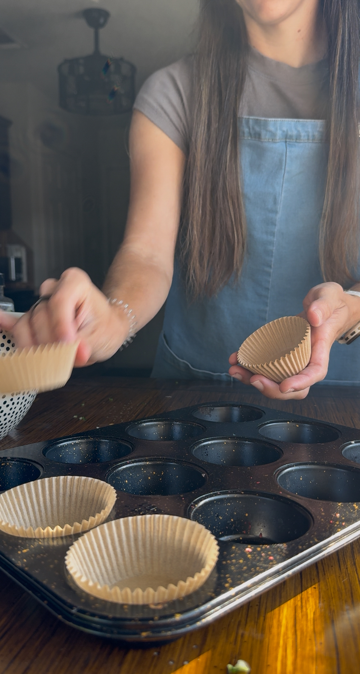adding the muffin liners into the muffin pan