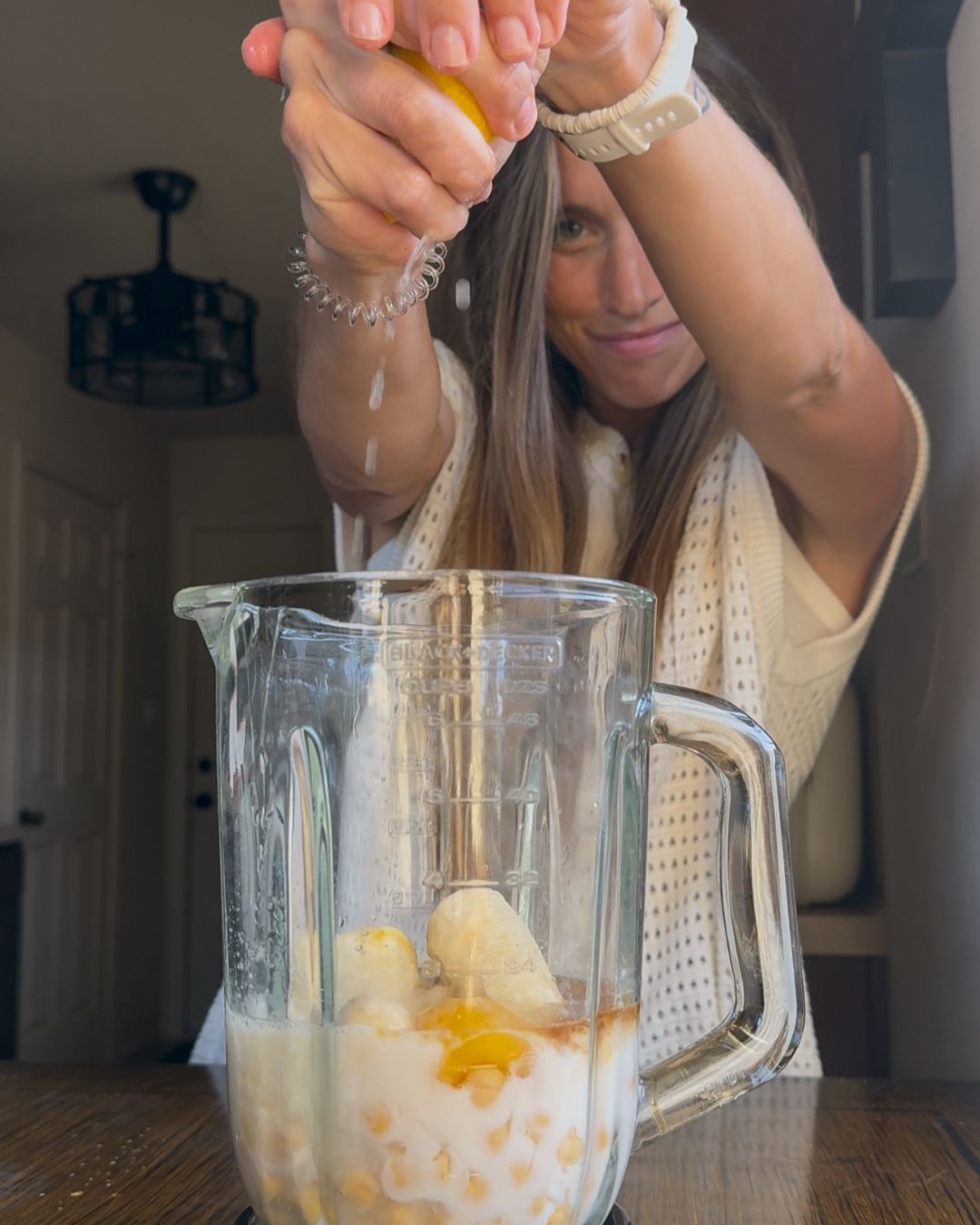 Adding the chickpeas, banana, eggs, milk, vanilla, lemon juice, and zest to a blender, and blend until smooth