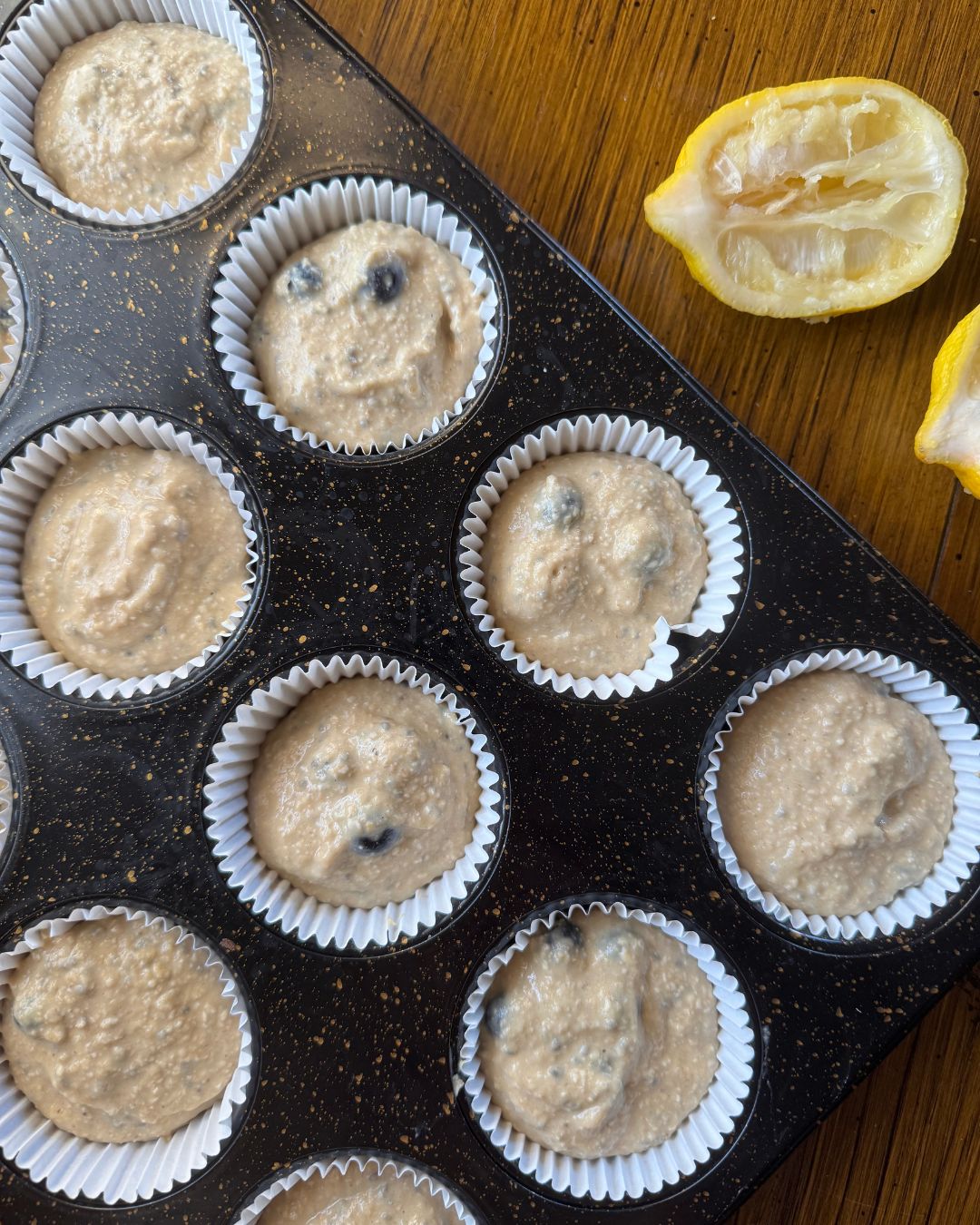 adding the blueberries and chia seeds and pouring into muffin wells