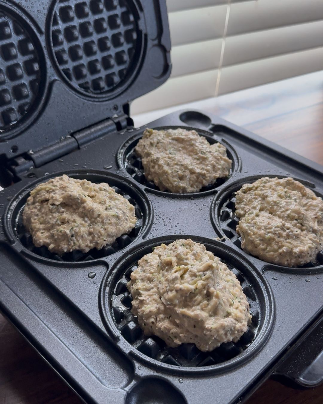 pouring waffle into waffle maker