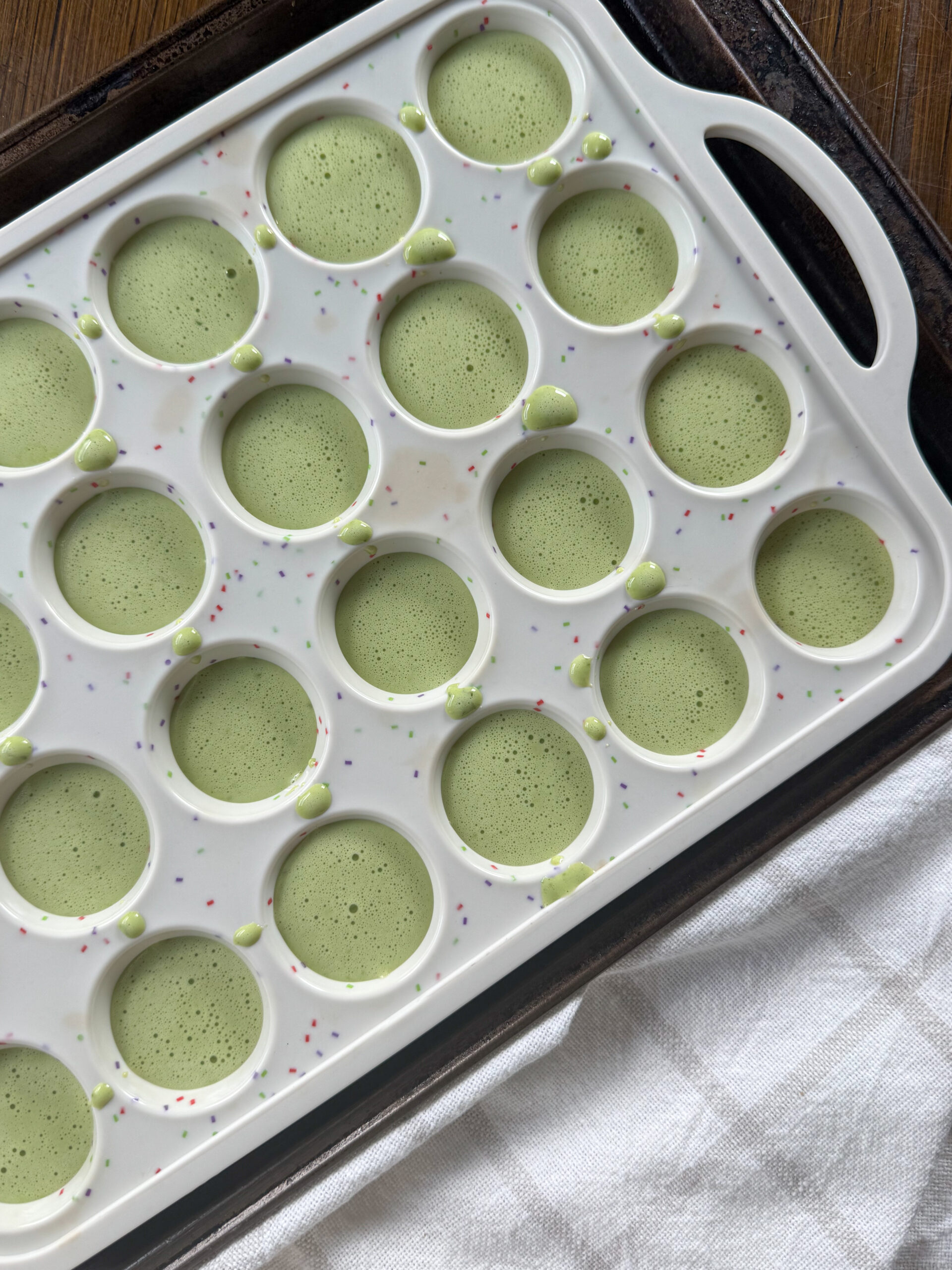 pouring the egg bite mixture into the mini muffin pan
