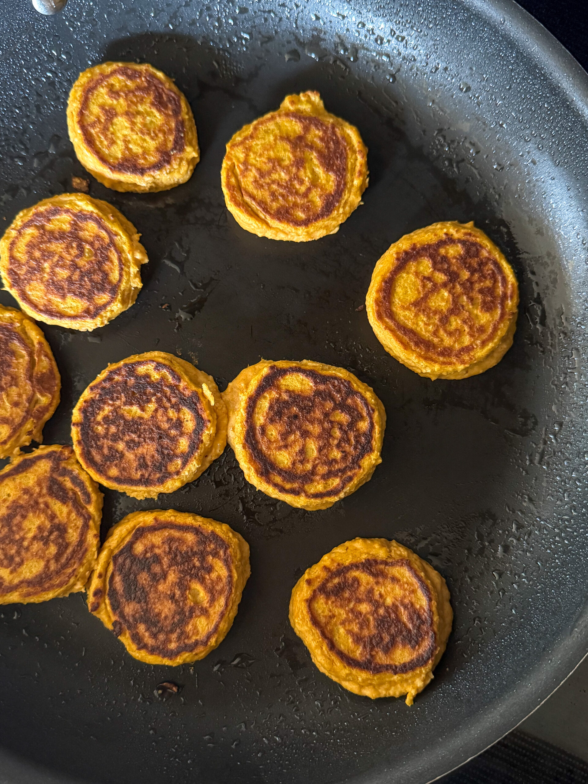 mini sweet potato pancakes on a skillet