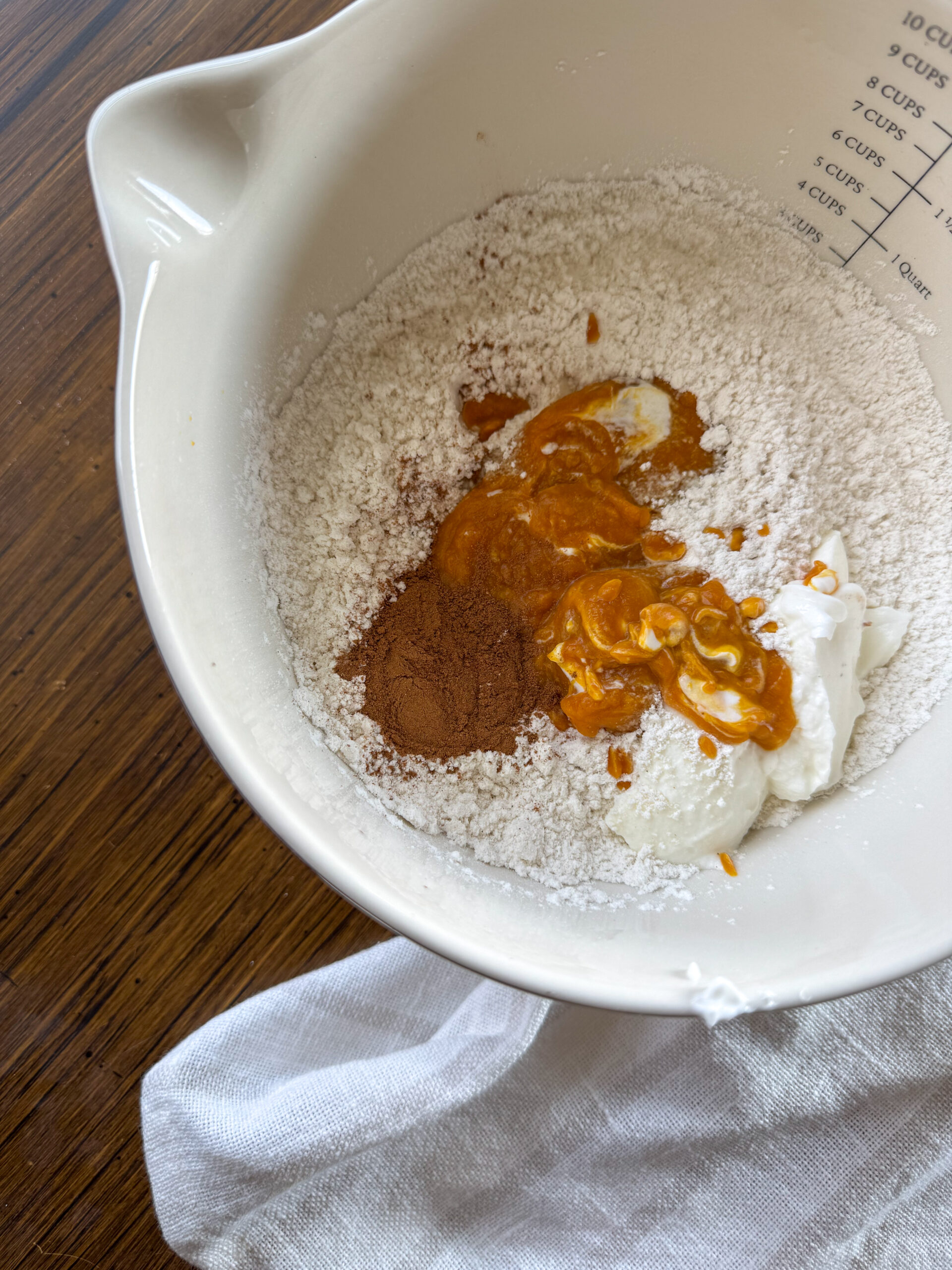 mixing the ingredients for pumpkin yogurt bagels in mixing bowl