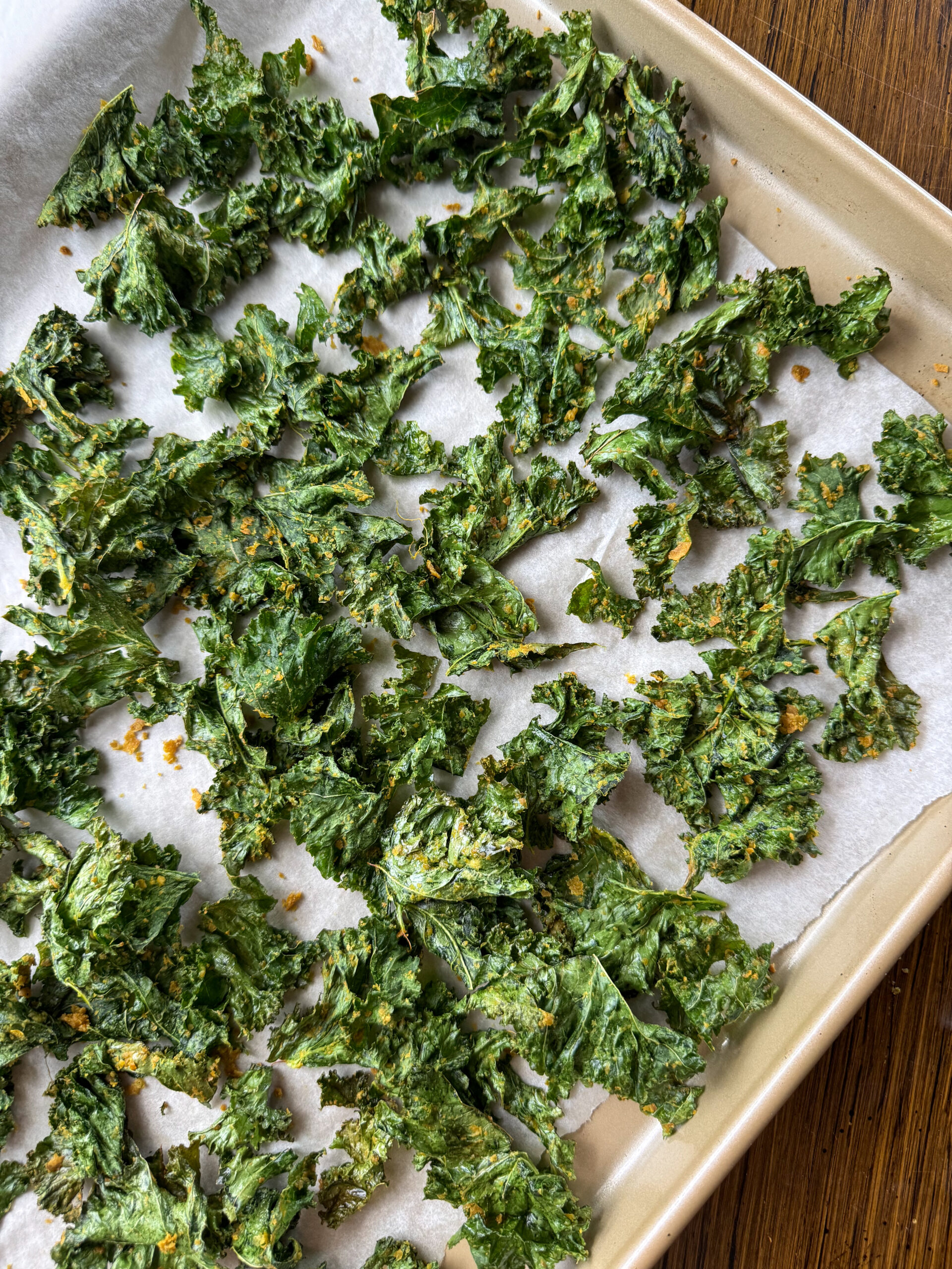 finished toddler friendly kale chips from the oven laying on a sheet pan