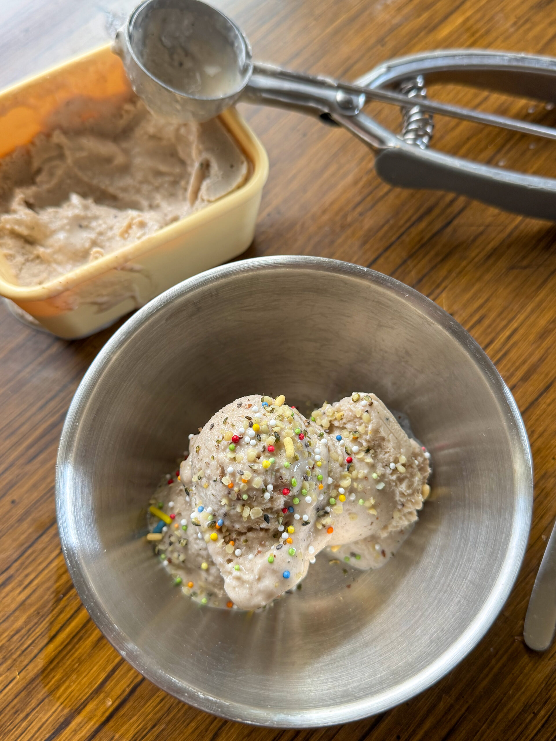 scoops of peanut butter banana ice cream with hemp hearts sprinkled on top