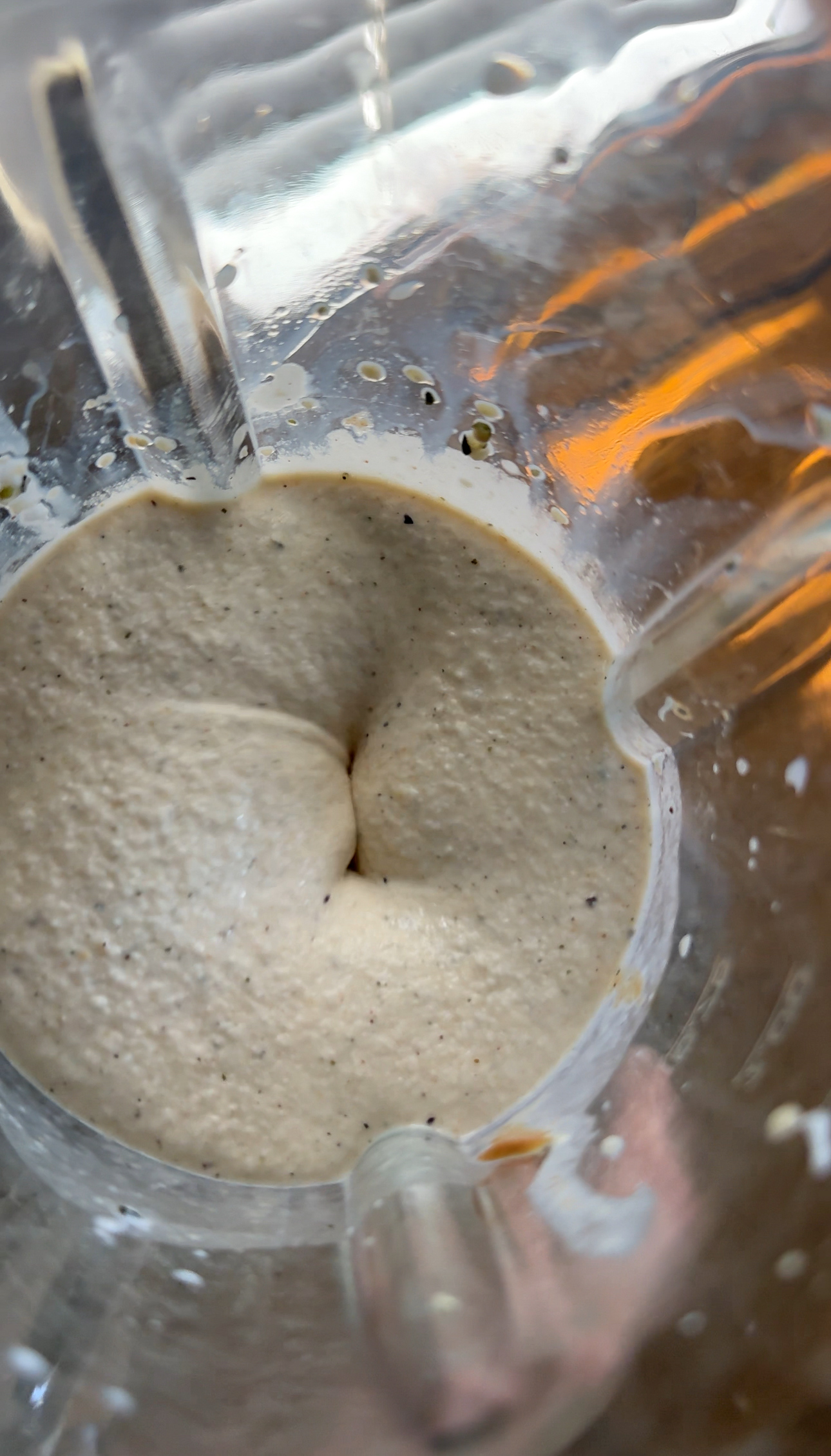 blending the frozen banana mixture with peanut butter, hemp hearts, milk, and yogurt