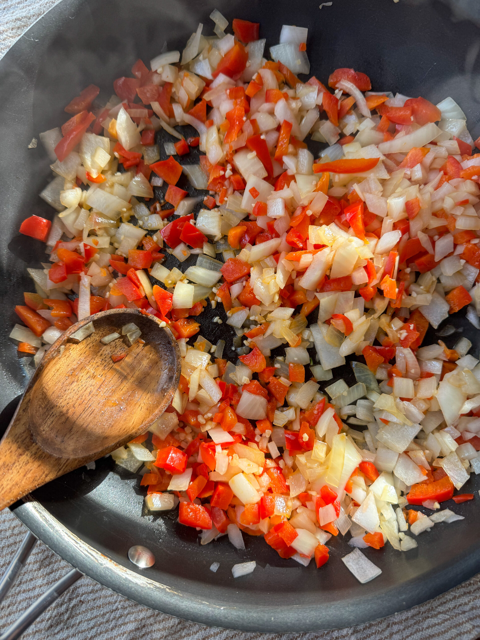 sauteing the bell peppers and onions together in a skillet