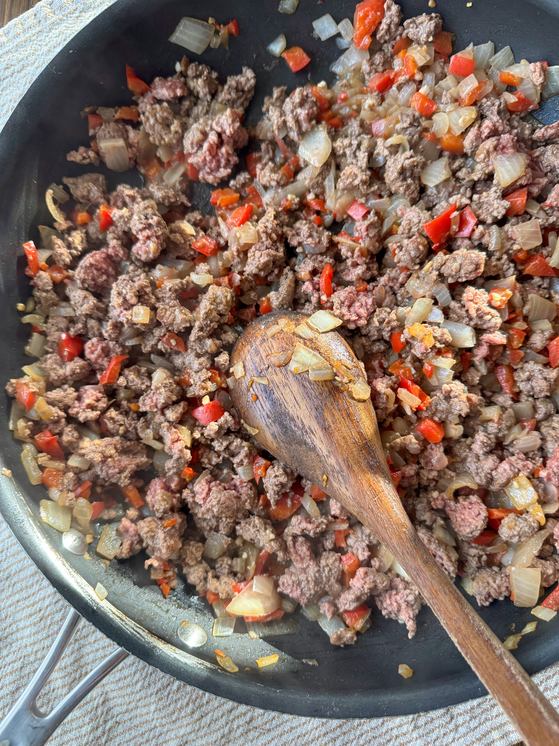 adding the ground meat into the veggie mixture