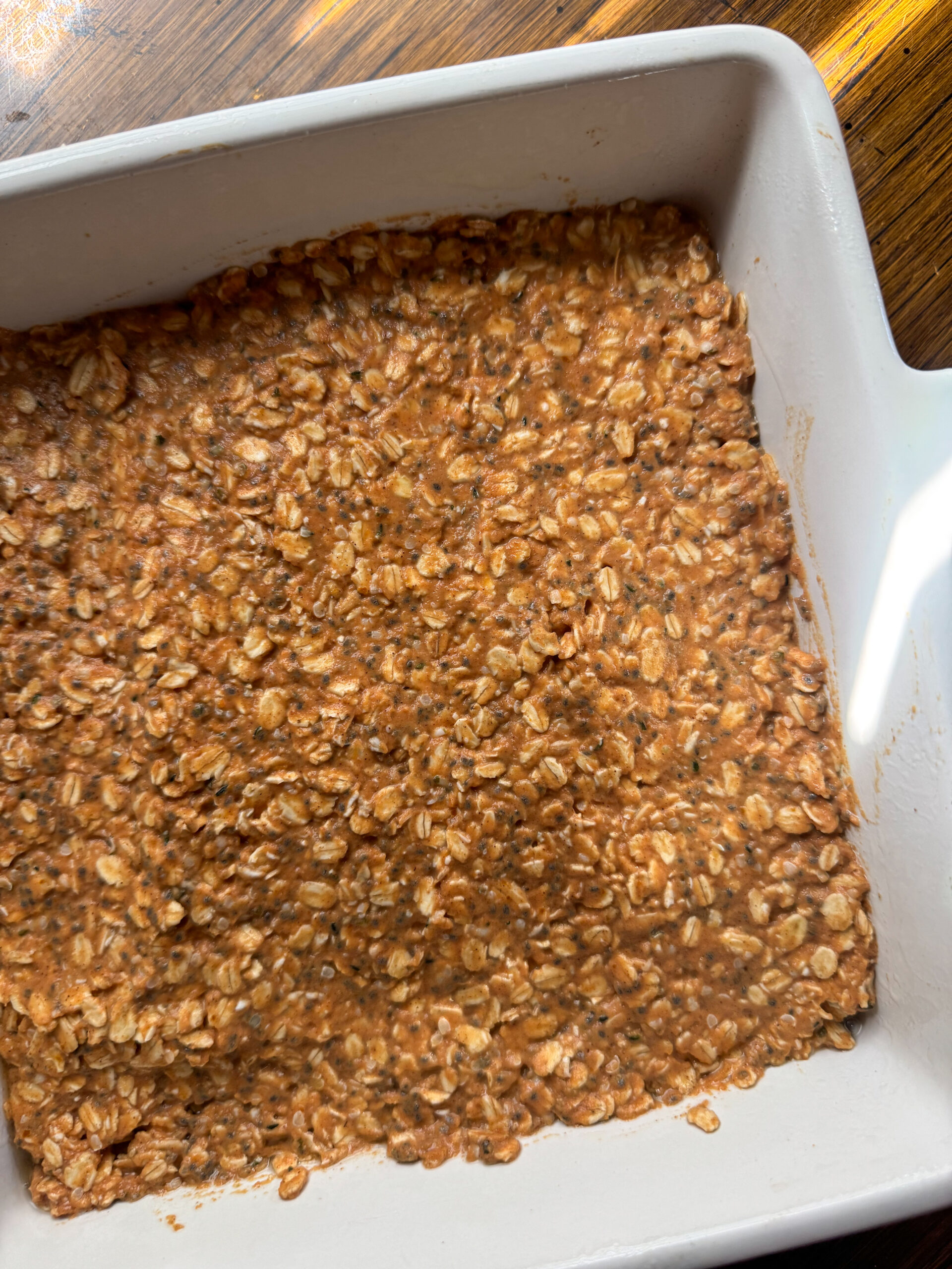 pumpkin oatmeal bar batter spread in a pan