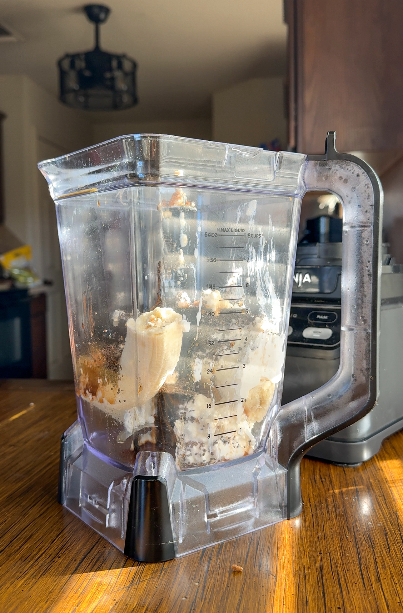 adding banana, chia seeds, vanilla, cottage cheese, and cinnamon into blender