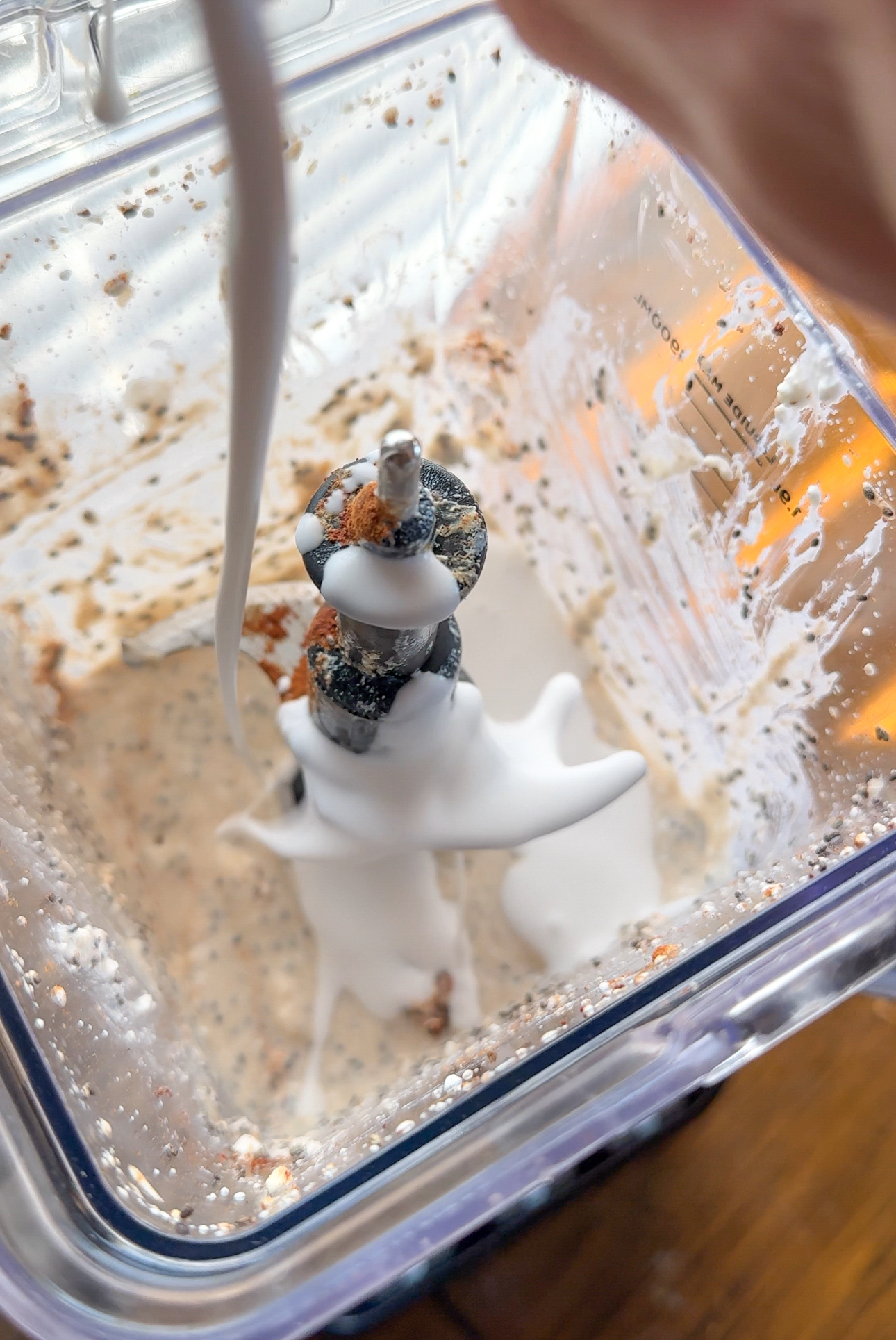 adding milk into the blender