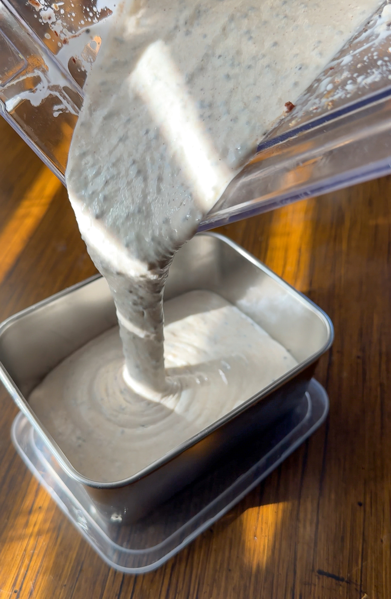 pouring banana chia pudding into container