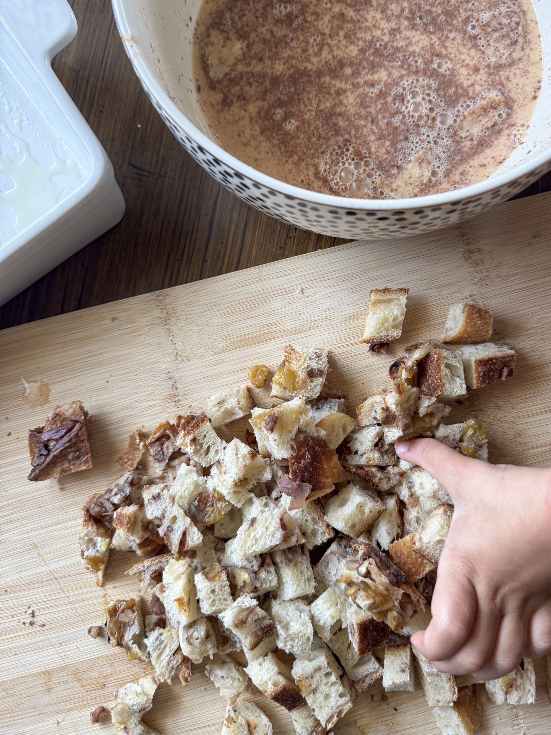 adding the cubed bread into the egg mixture