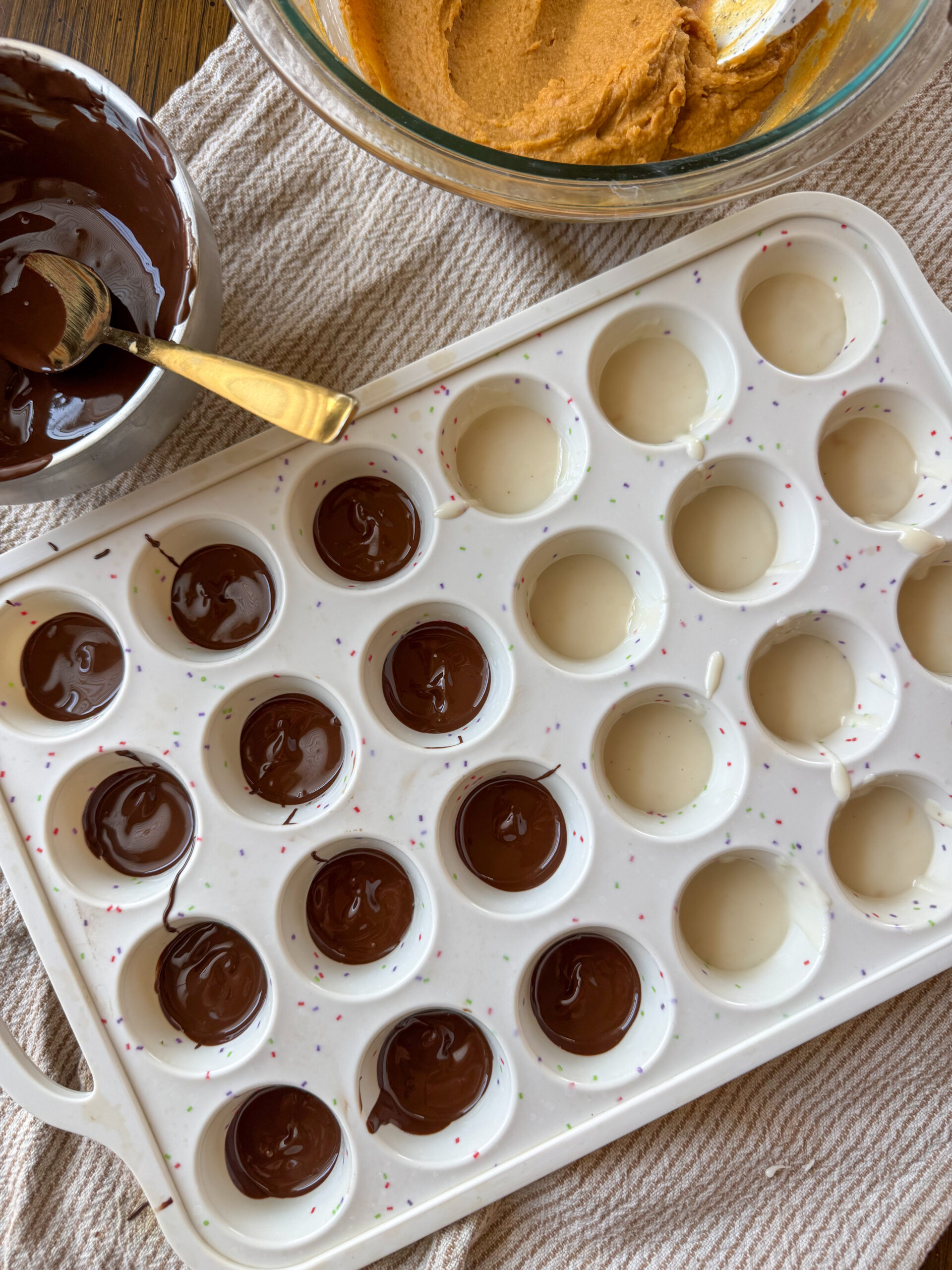 filling muffin pan with chocolate for peanut butter cups