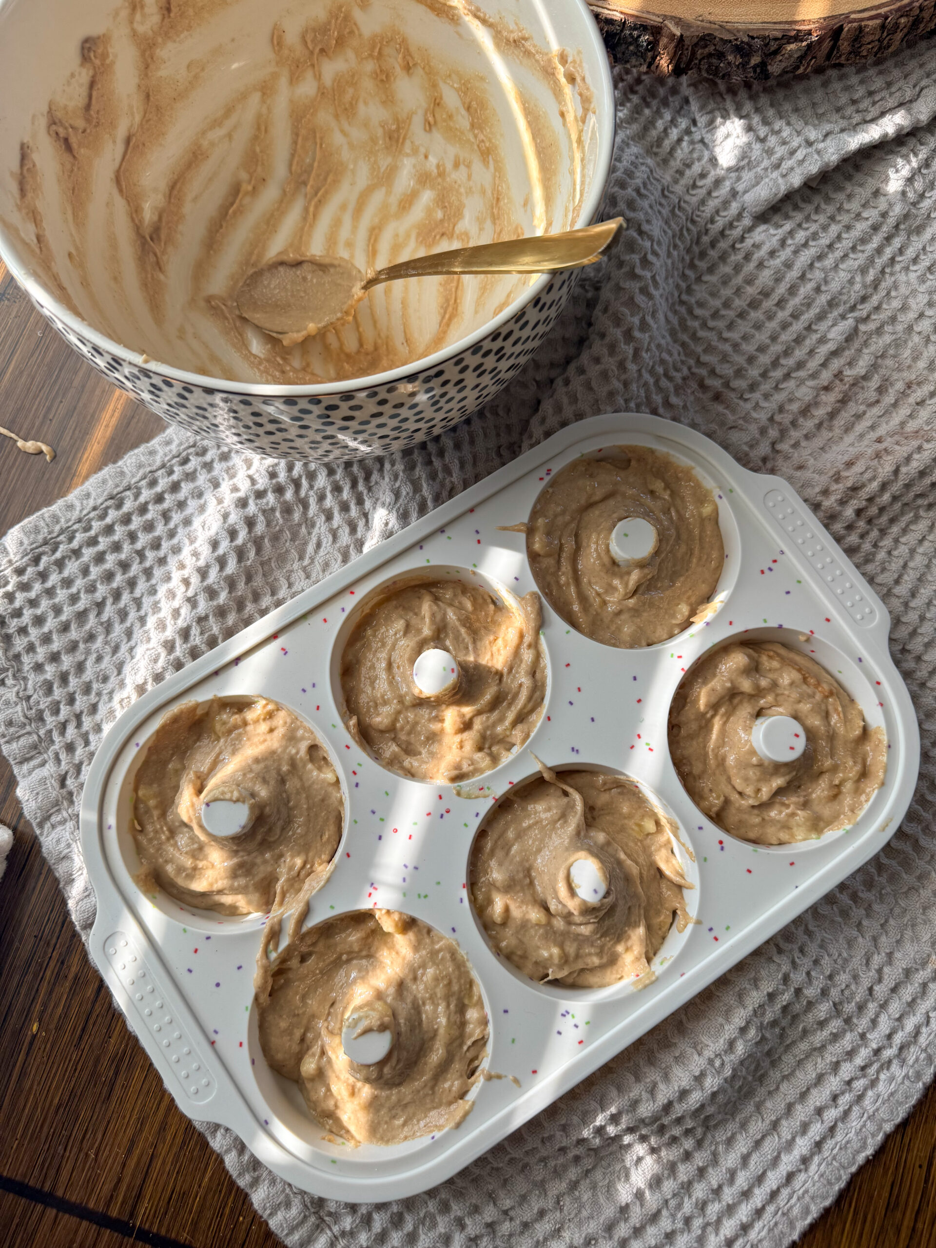 putting batter into the donut pan