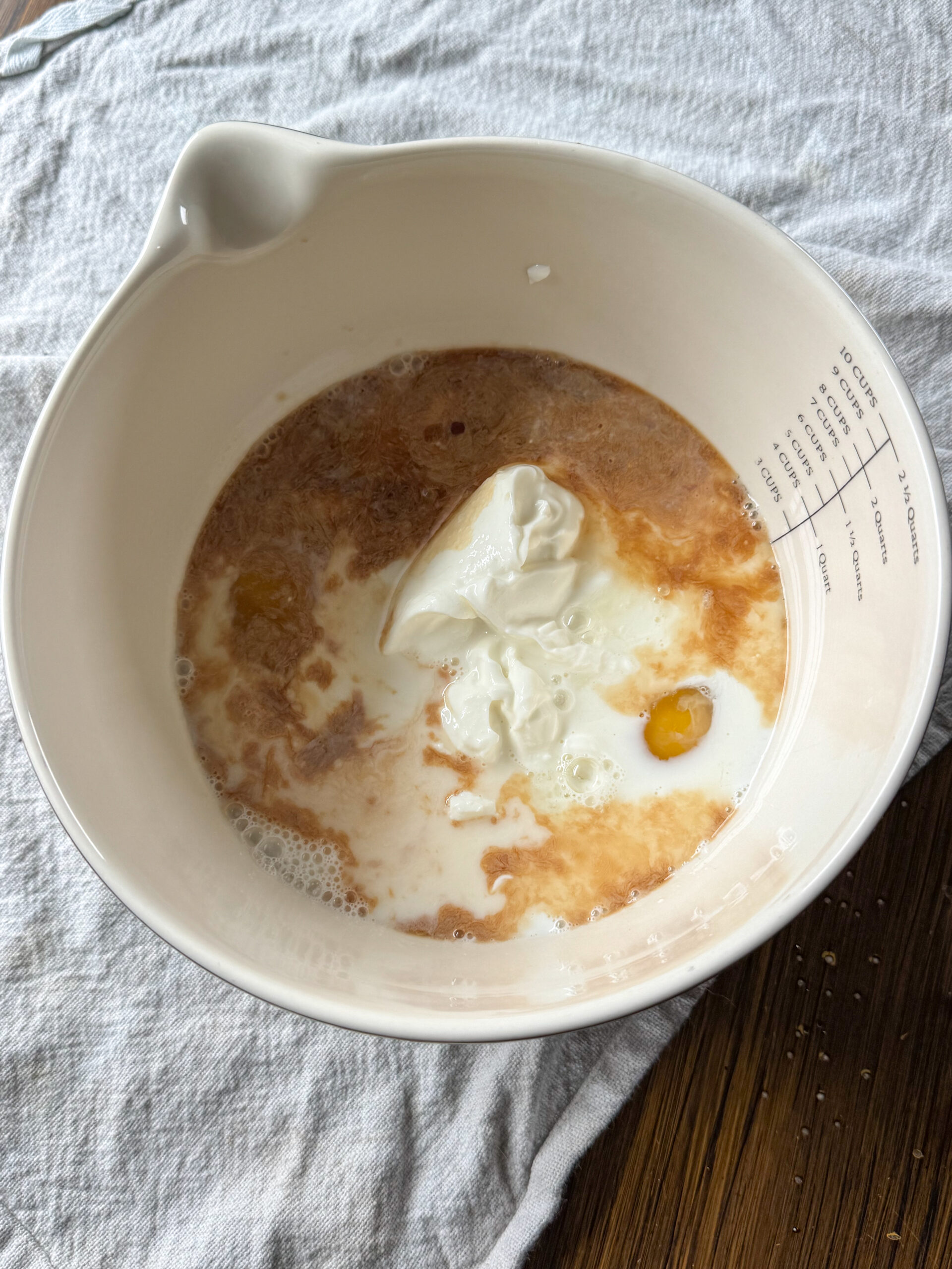 adding wet ingredients in a bowl