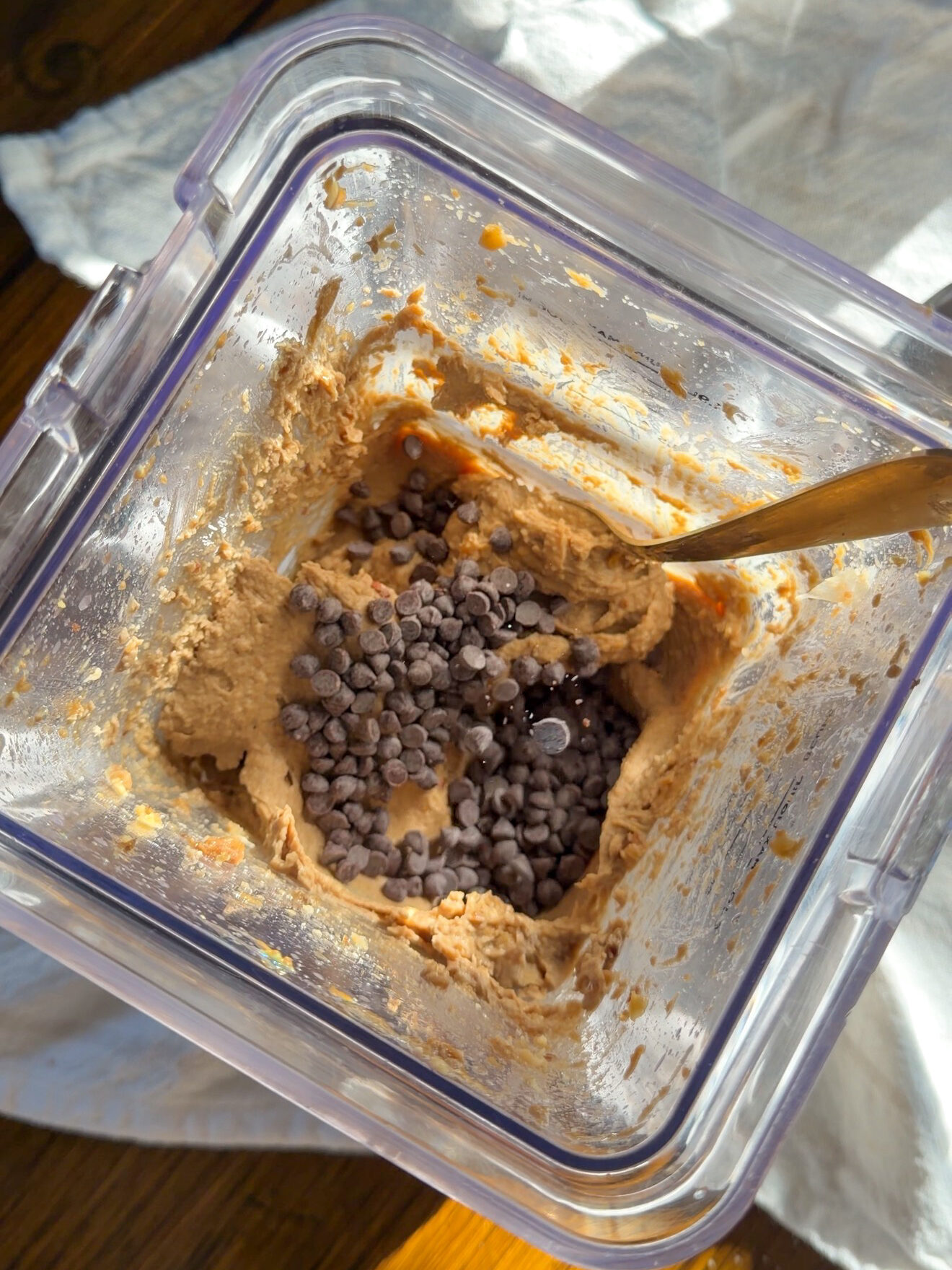 adding chocolate chips into the chickpea cookie dough