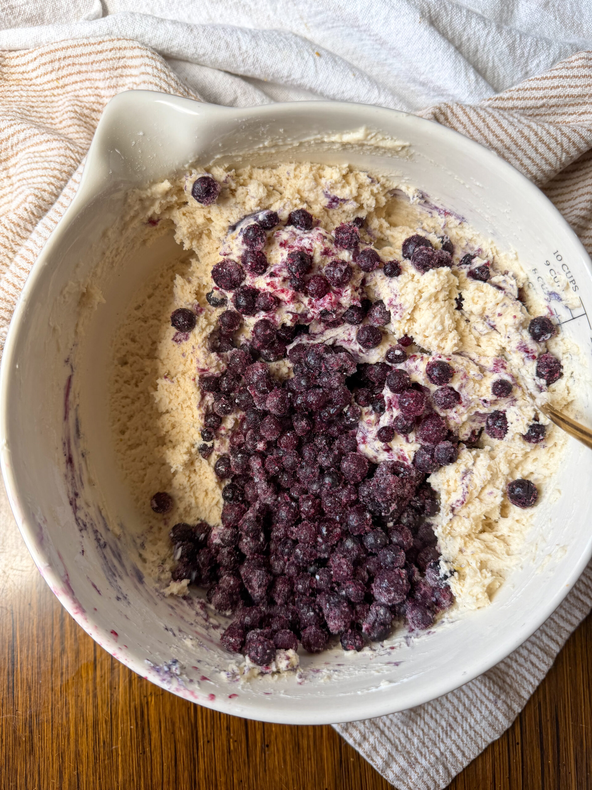 folding the blueberries into the muffin dough
