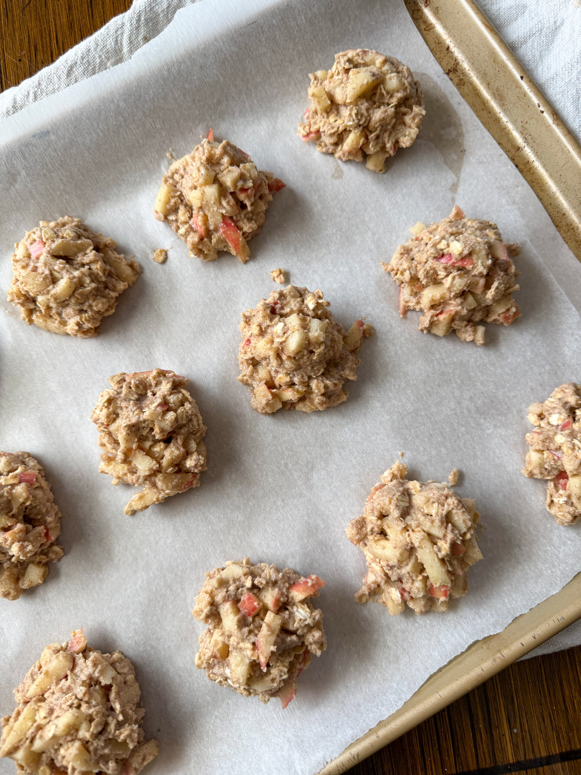 healthy baked apple fritters on a sheet pan about to be baked
