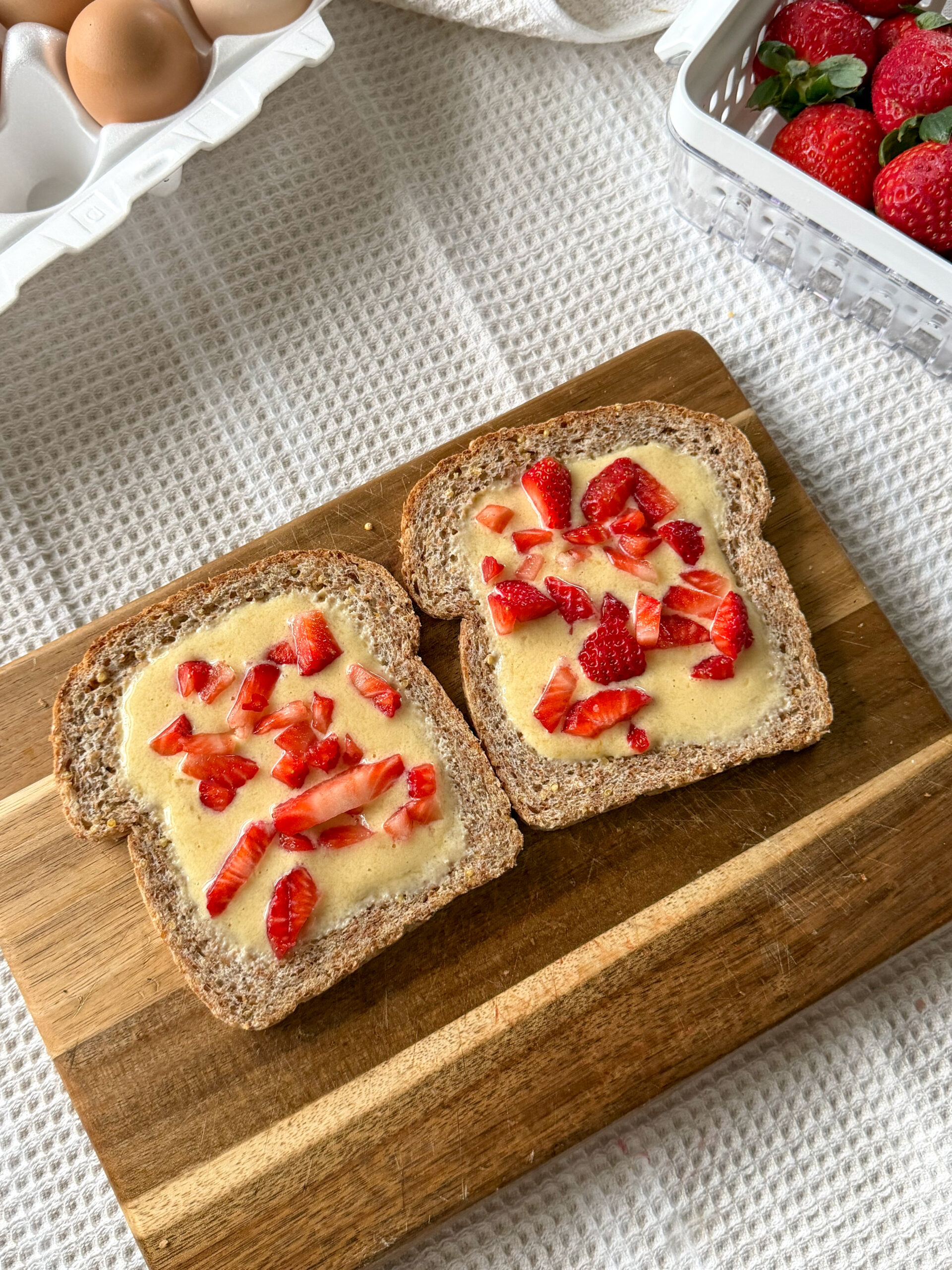 topping the easy toast with strawberries