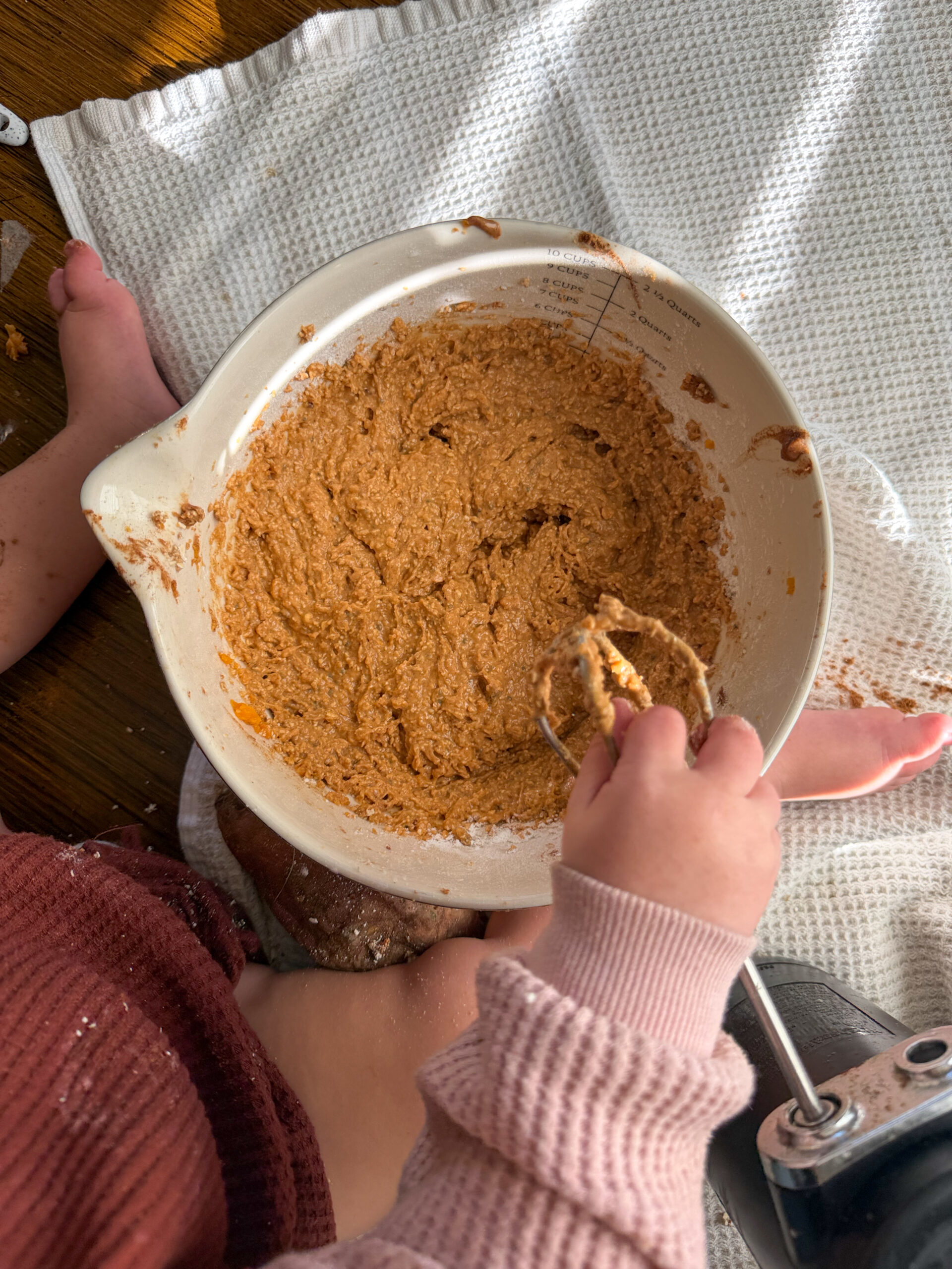 mixed ingredients in a bowl with baby help