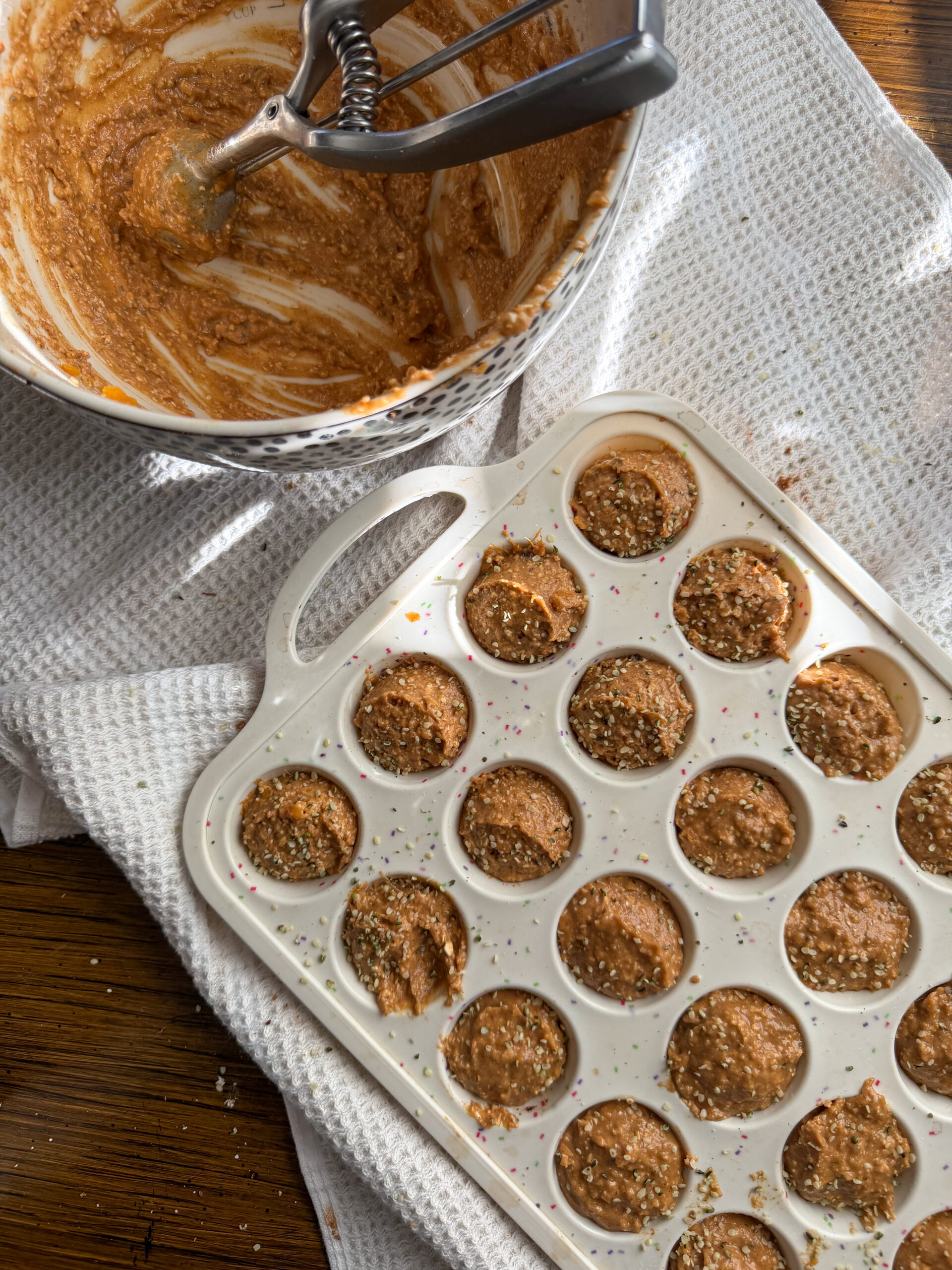 adding the dough to the muffin pan