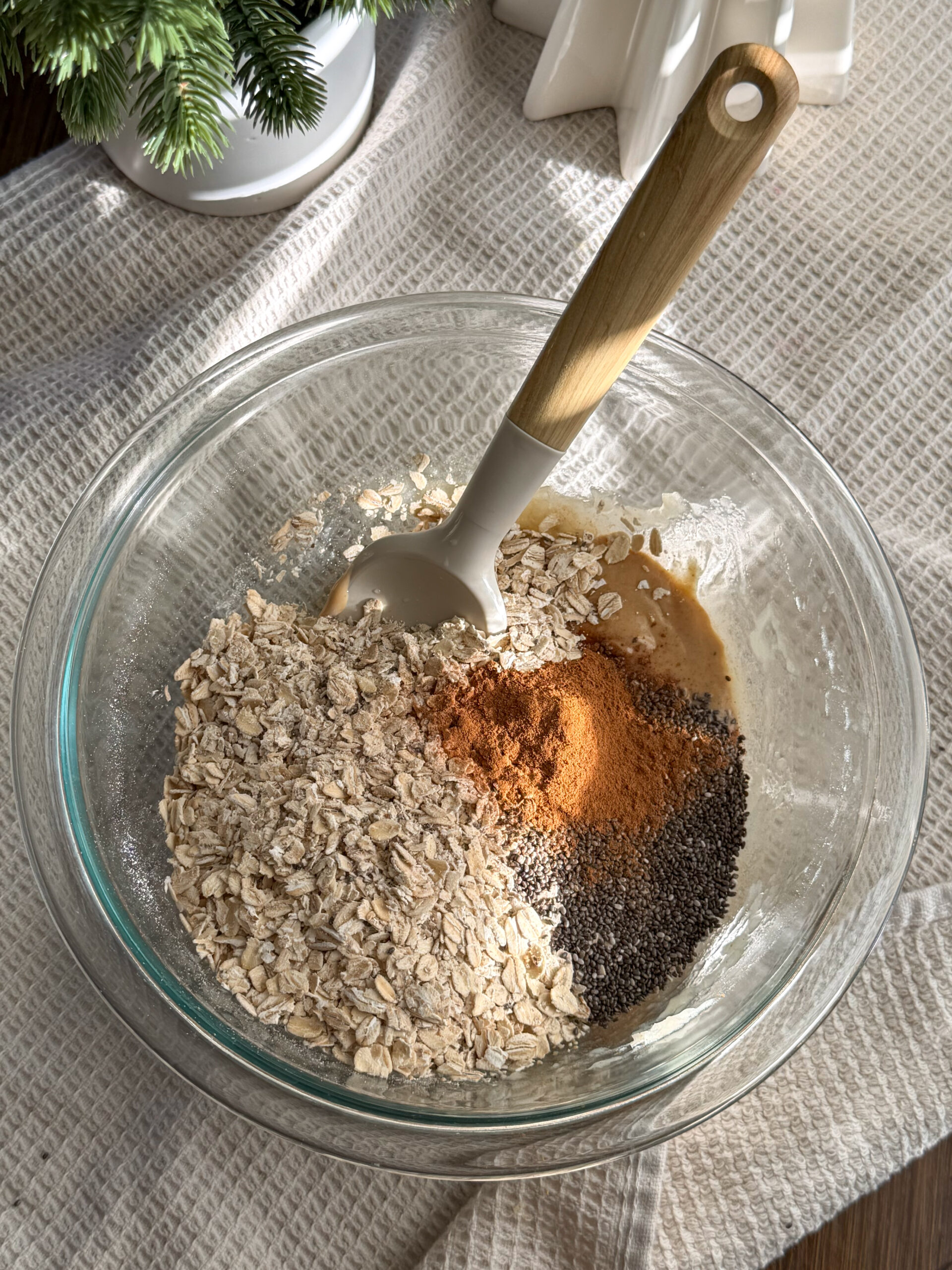 adding dry ingredients like oats and chia seeds into a bowl