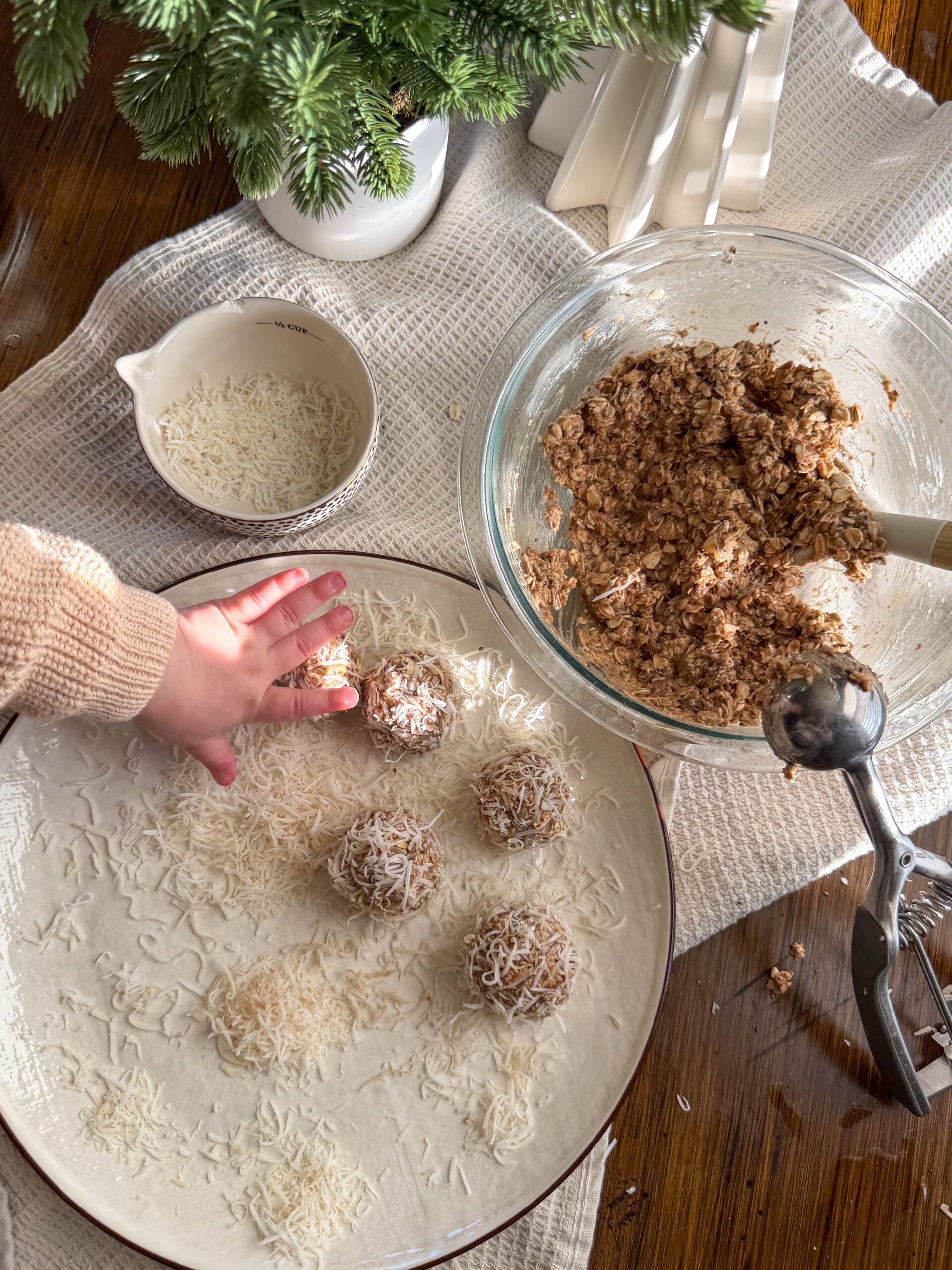 rolling the coconut banana energy bites into balls and coating with coconut