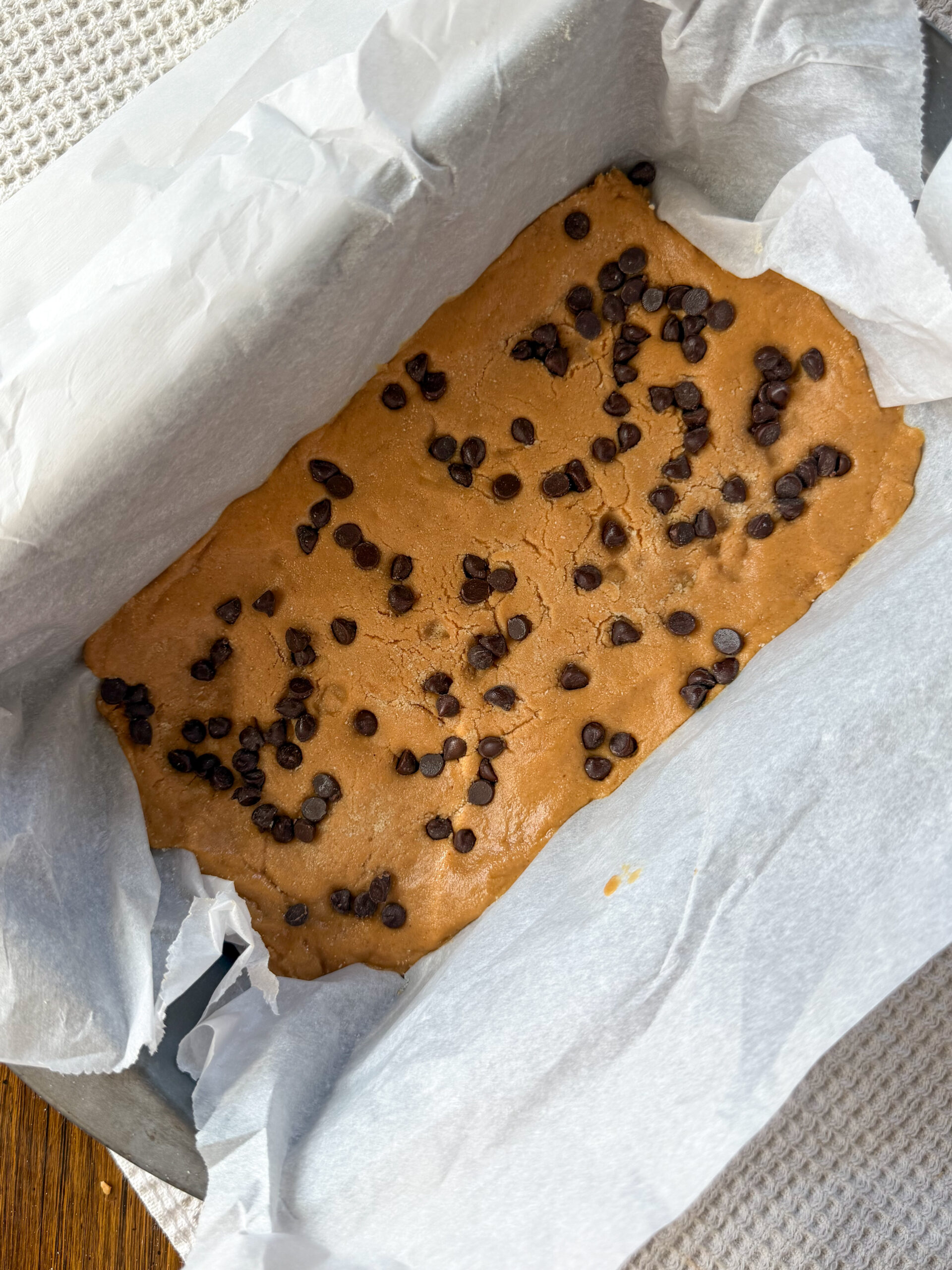 adding chocolate chips to peanut butter perfect bars copycat recipe