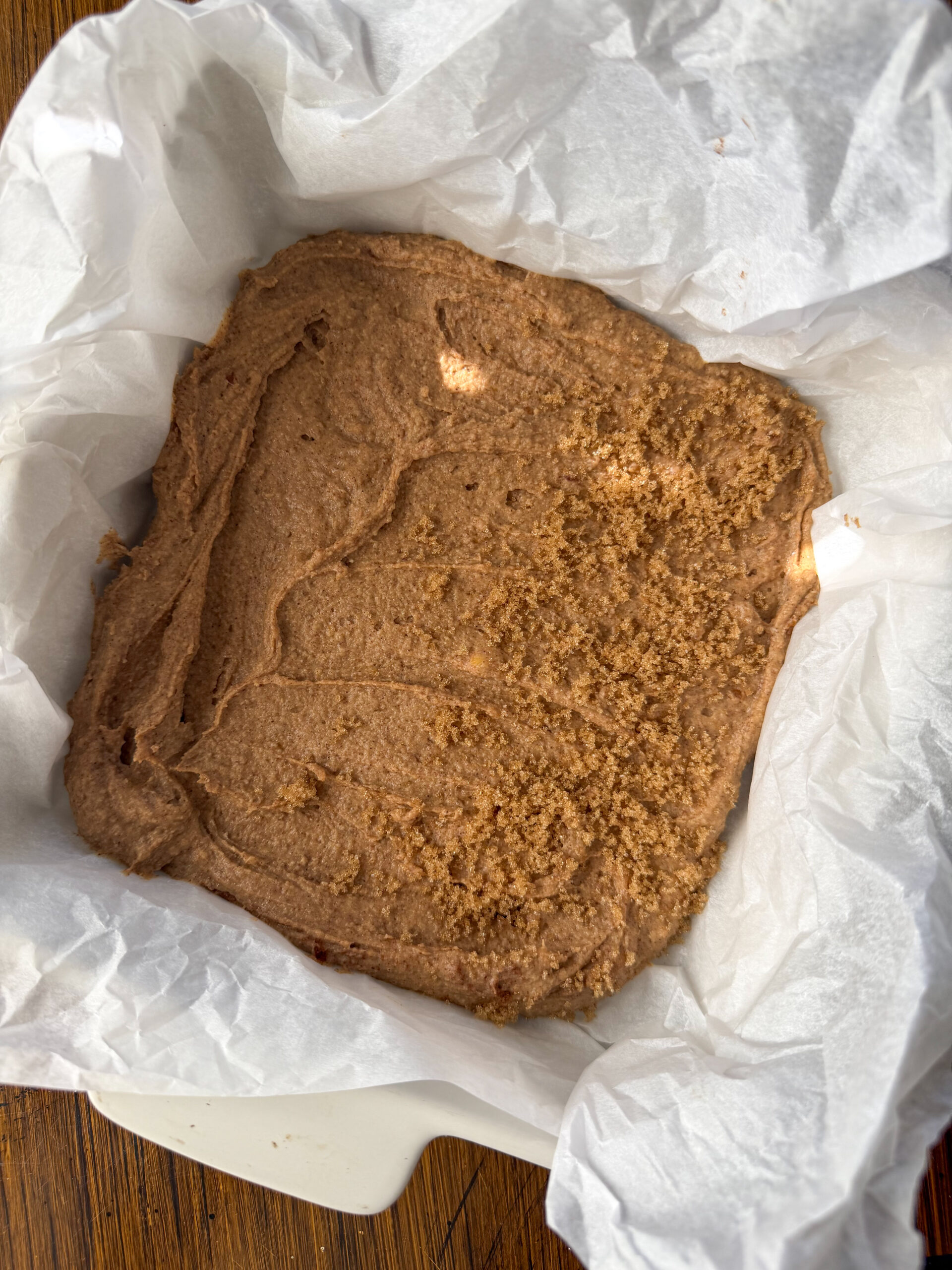 spreading the snickerdoodle chickpea blondies in a pan