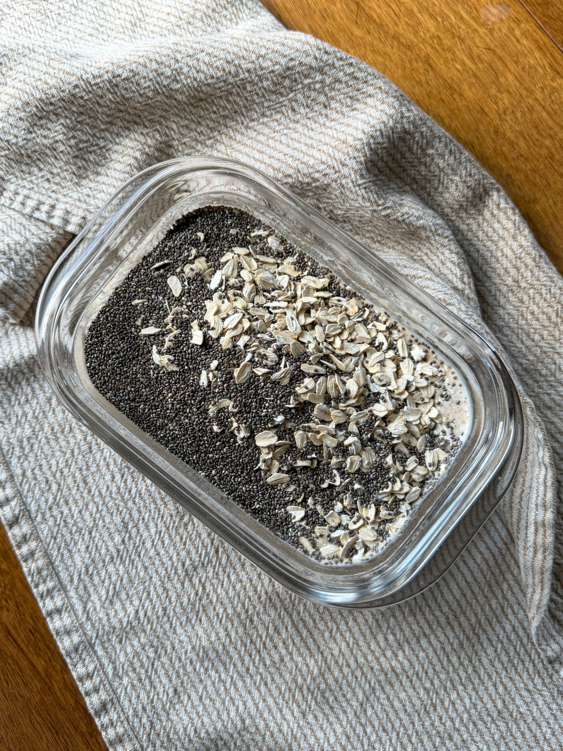 adding oats and chia seeds into date mixture