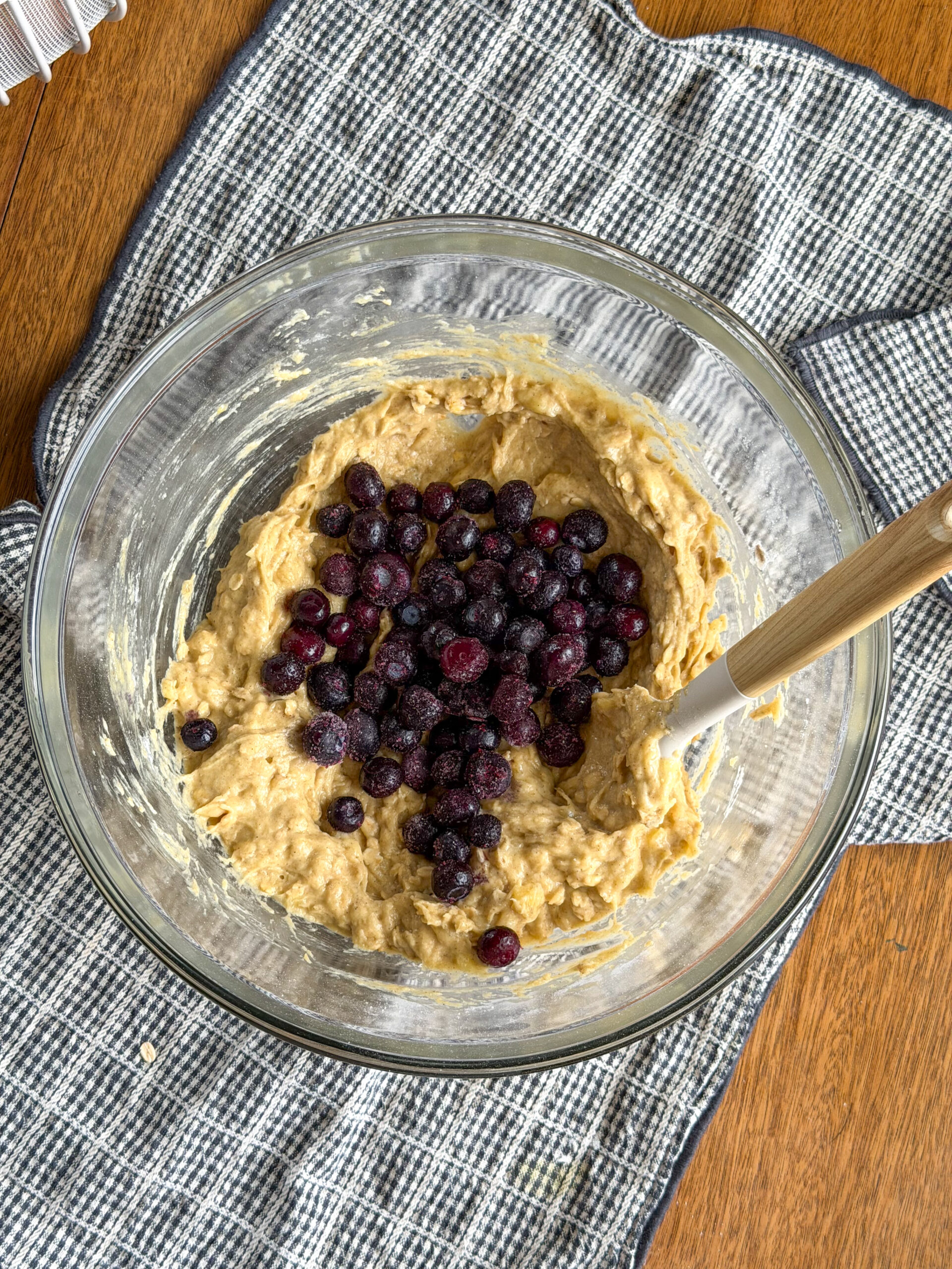 mixing the blueberries into the muffin batter