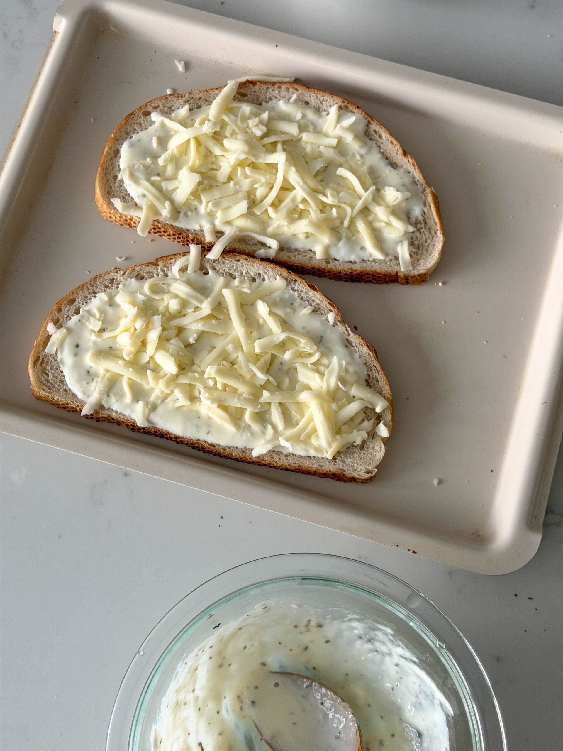sprinkling cheese on top of cottage cheese toast