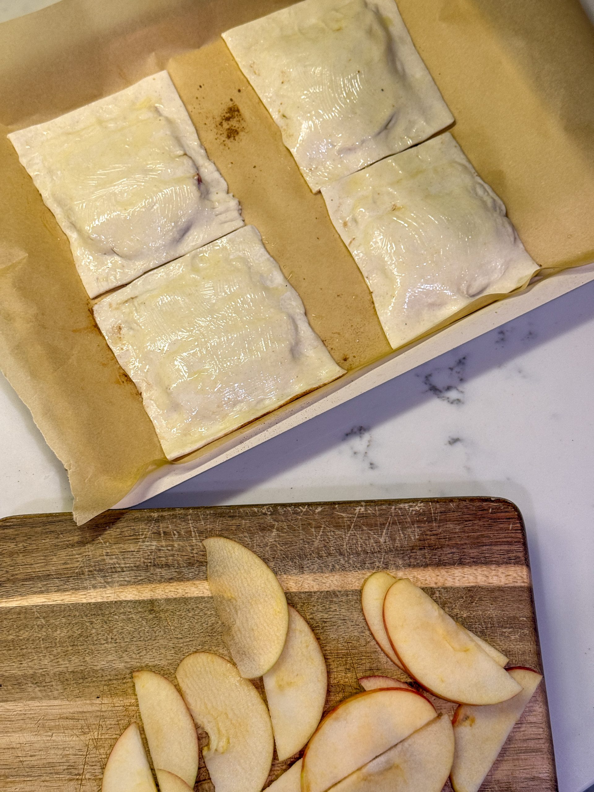 pressing dough on top of Upside Down Apple Turnovers for Toddlers